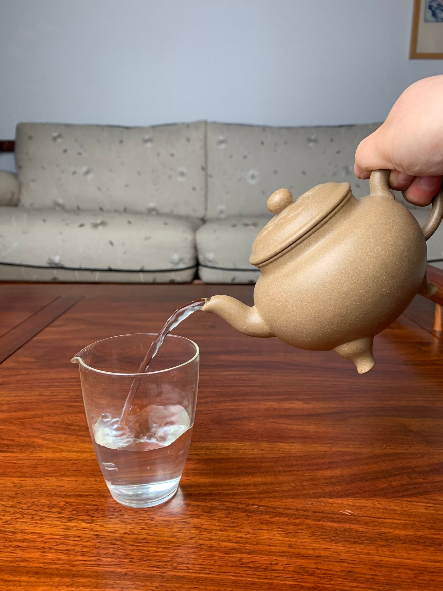 Purple clay teapot pour