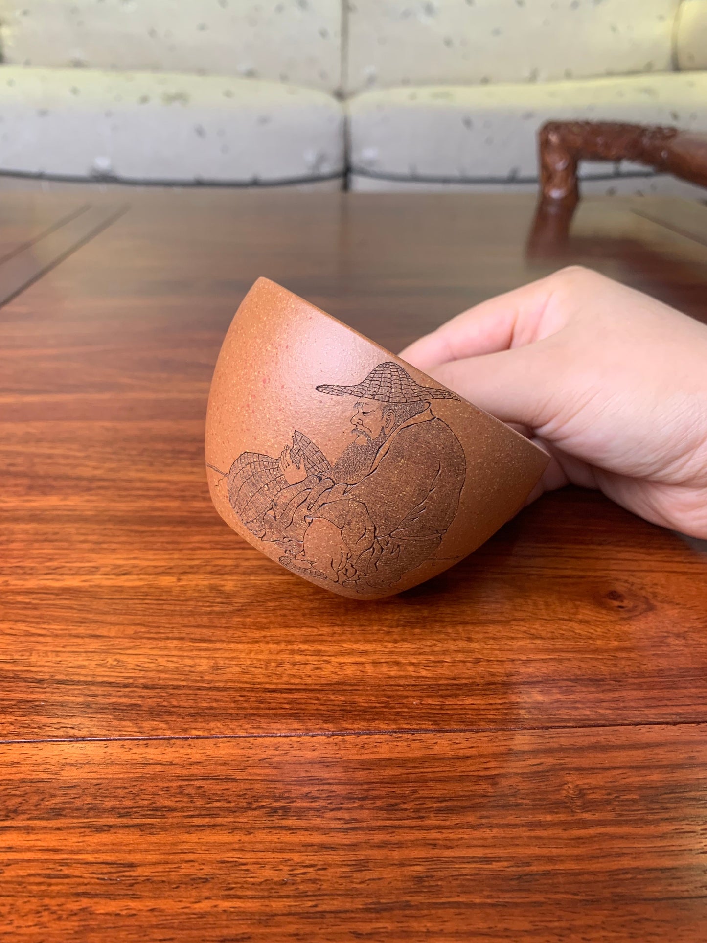 Teacup artwork named fishman on hand