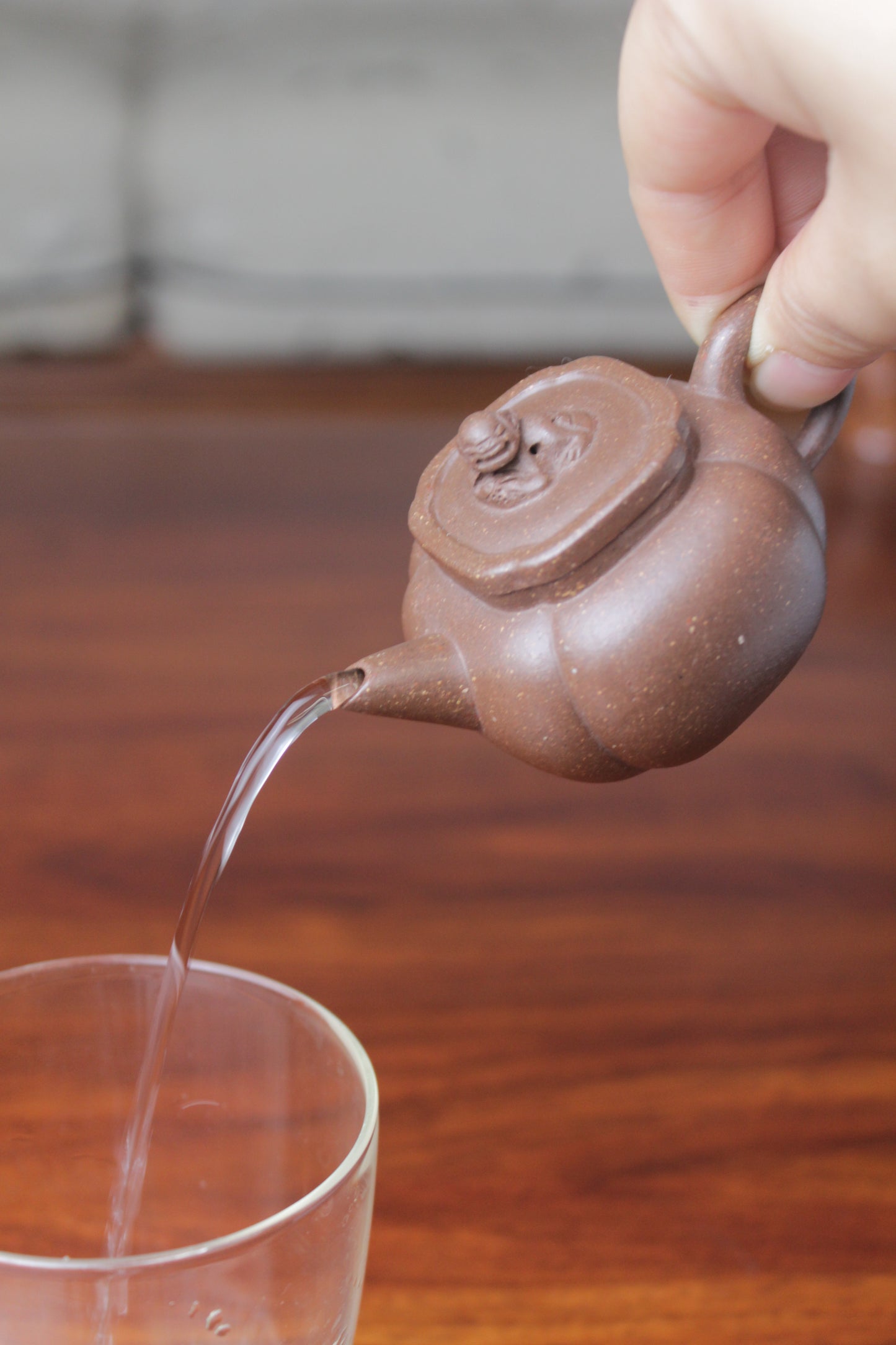 Pour of the Artistic teapot on the table