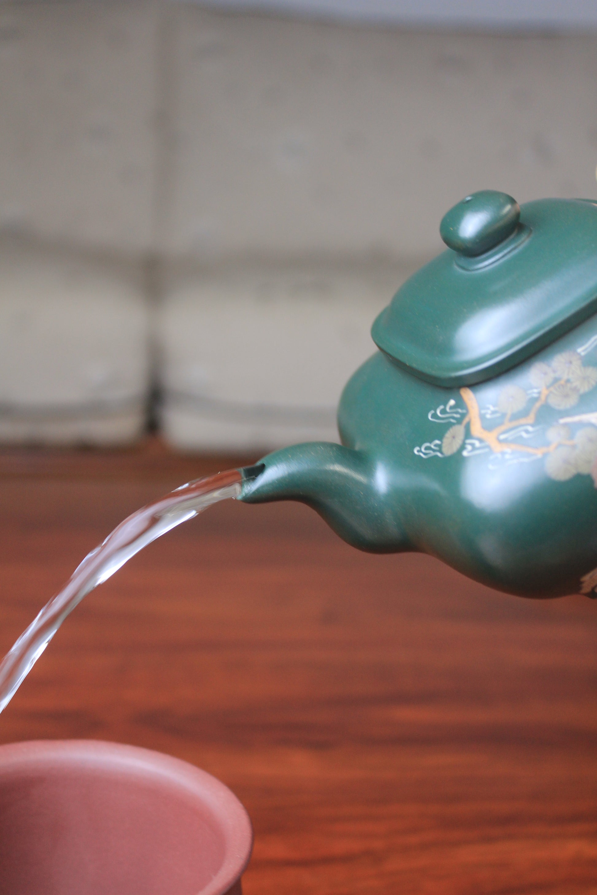 The pour of the Artistic teapot from teapot artist on the table