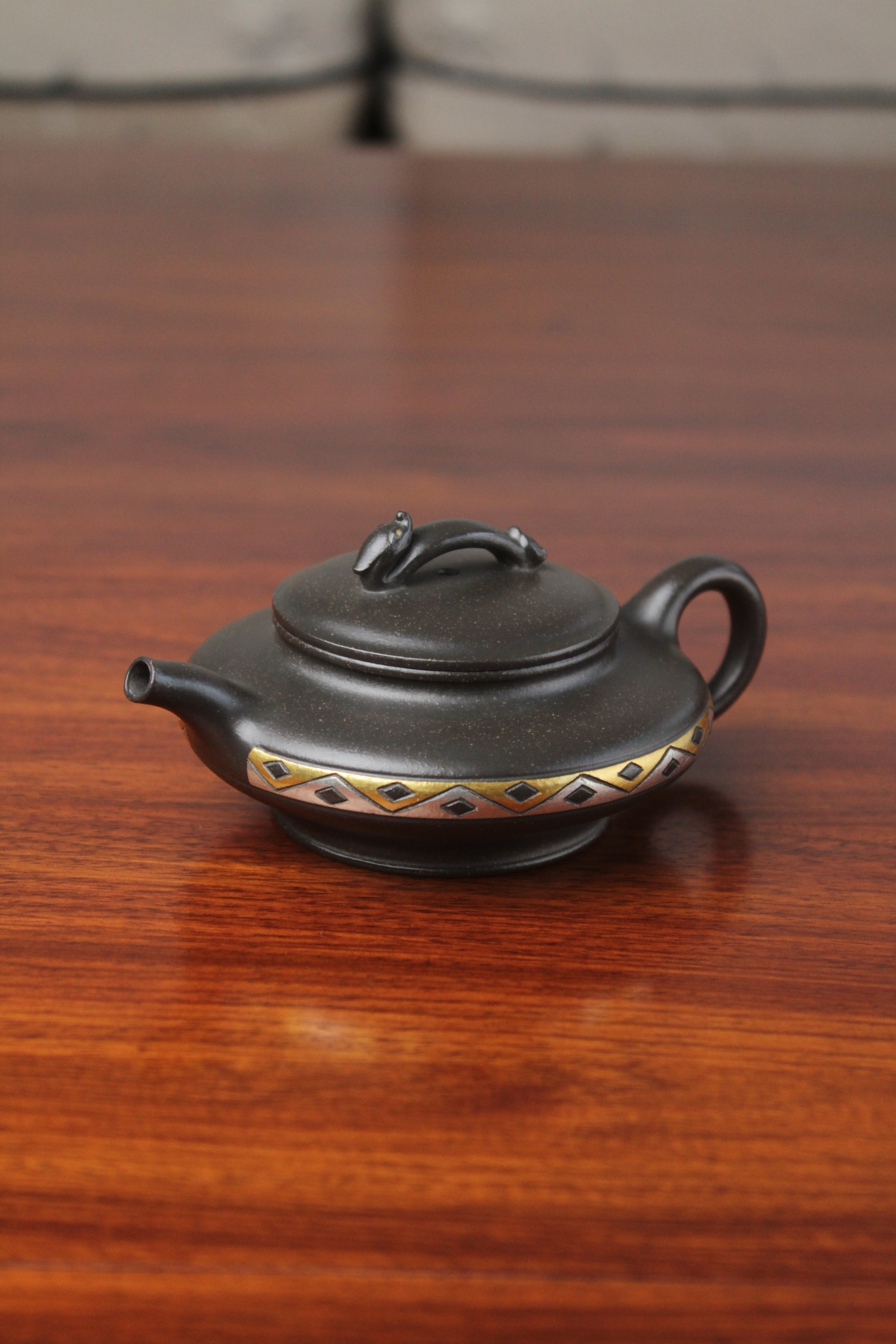 left detail of chinese pot made with purple clay from yixing zisha art gallery