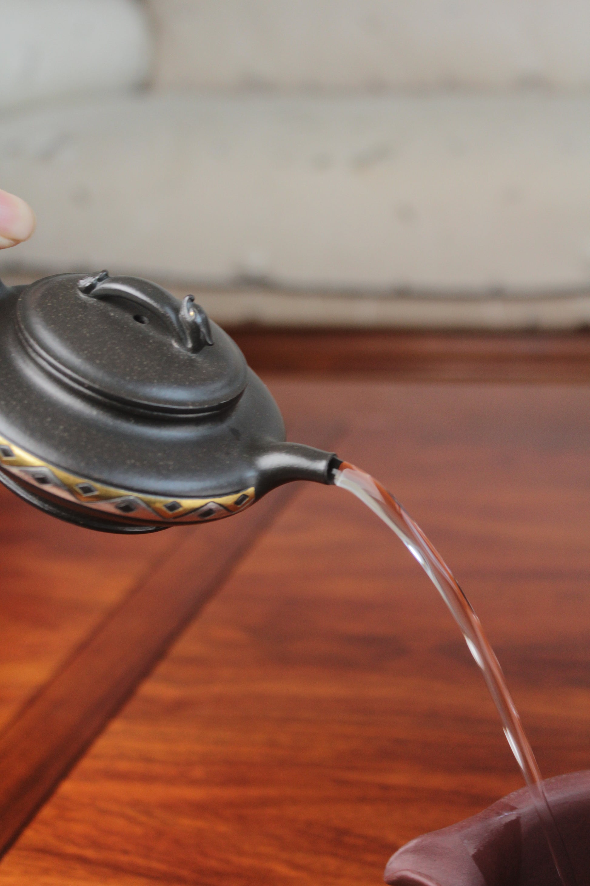 pour of chinese pot made with purple clay from yixing zisha art gallery