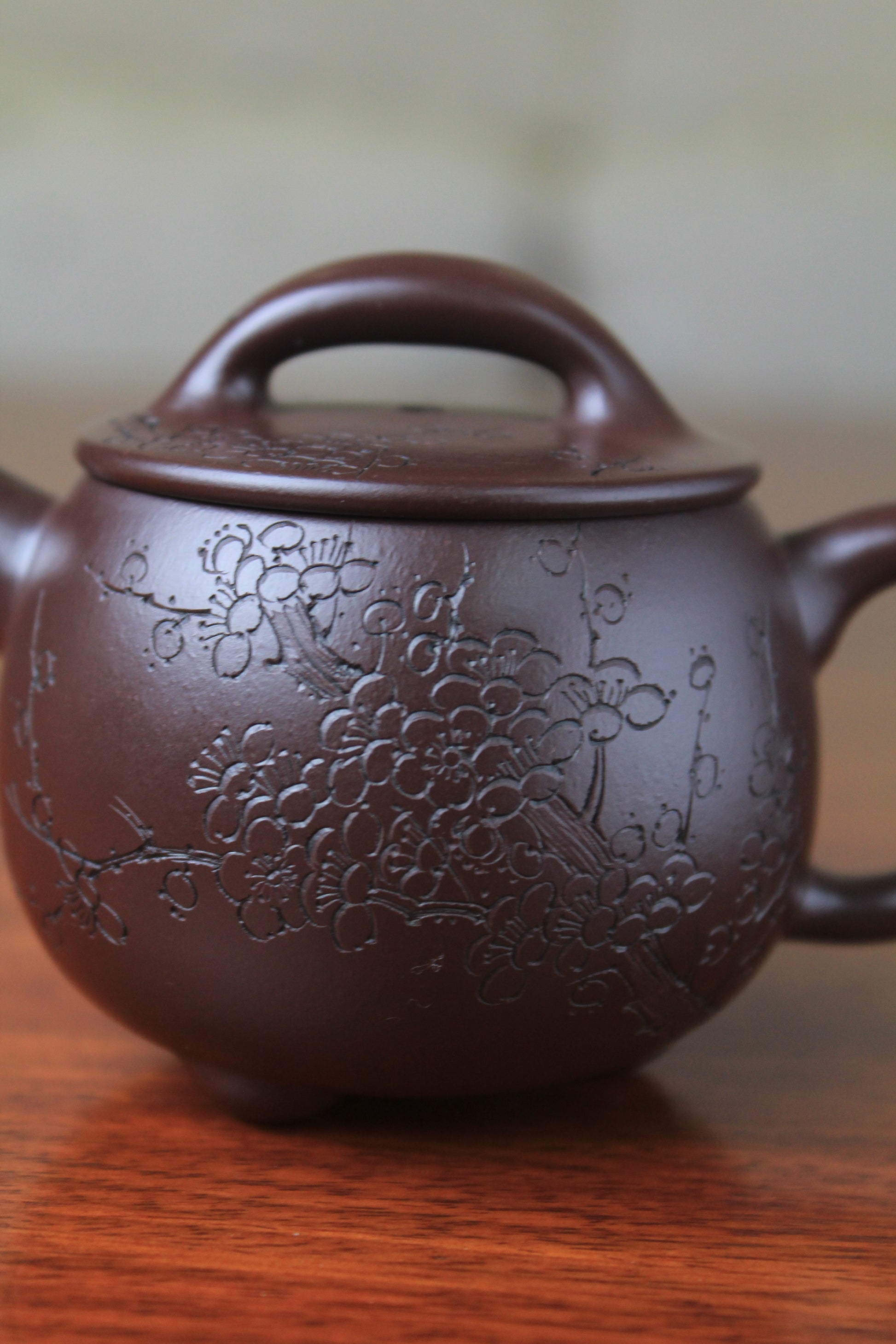 Pattern of Cute chinese teapot handmade with purple clay on the table
