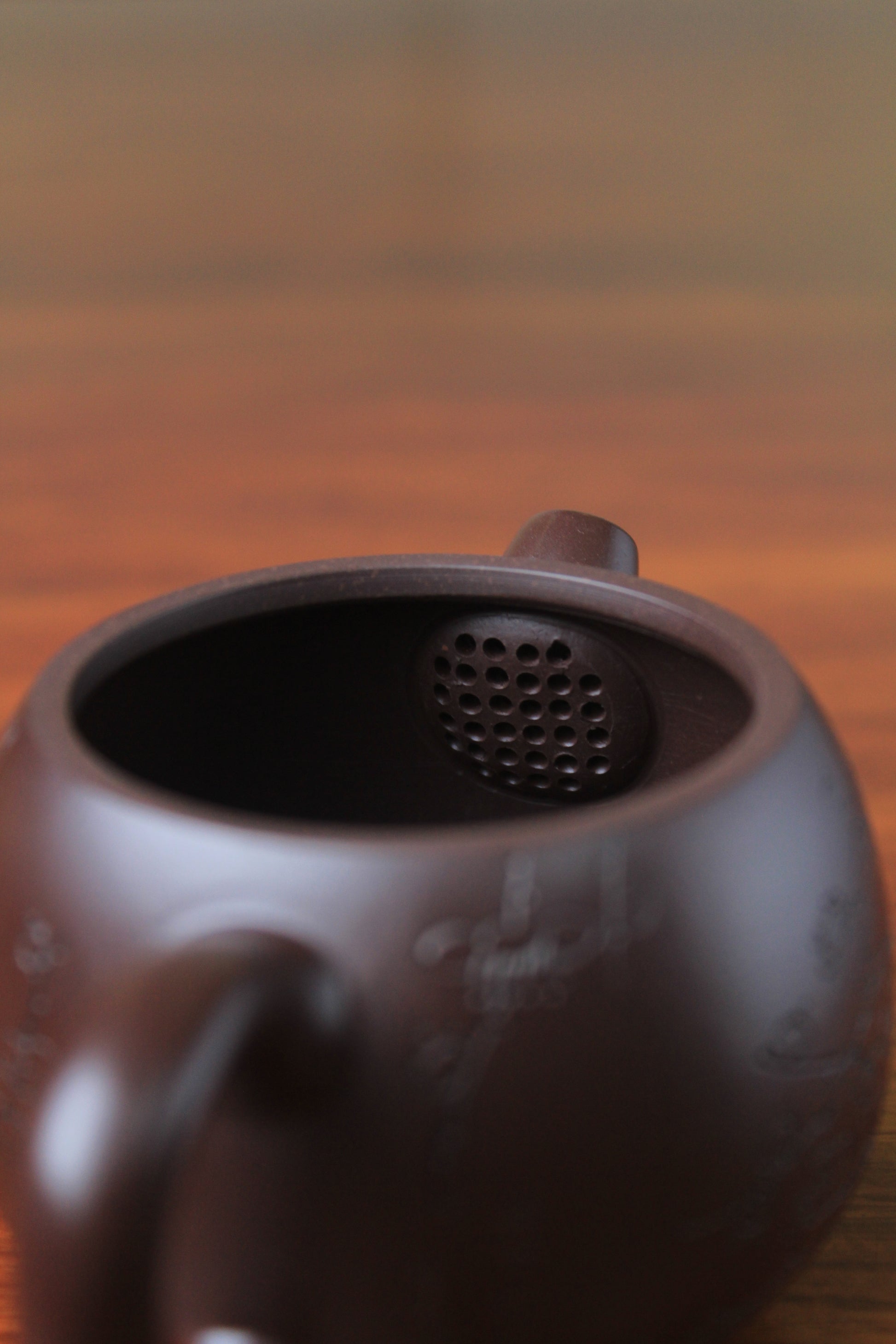 filter of chinese teapot handmade with purple clay on the table