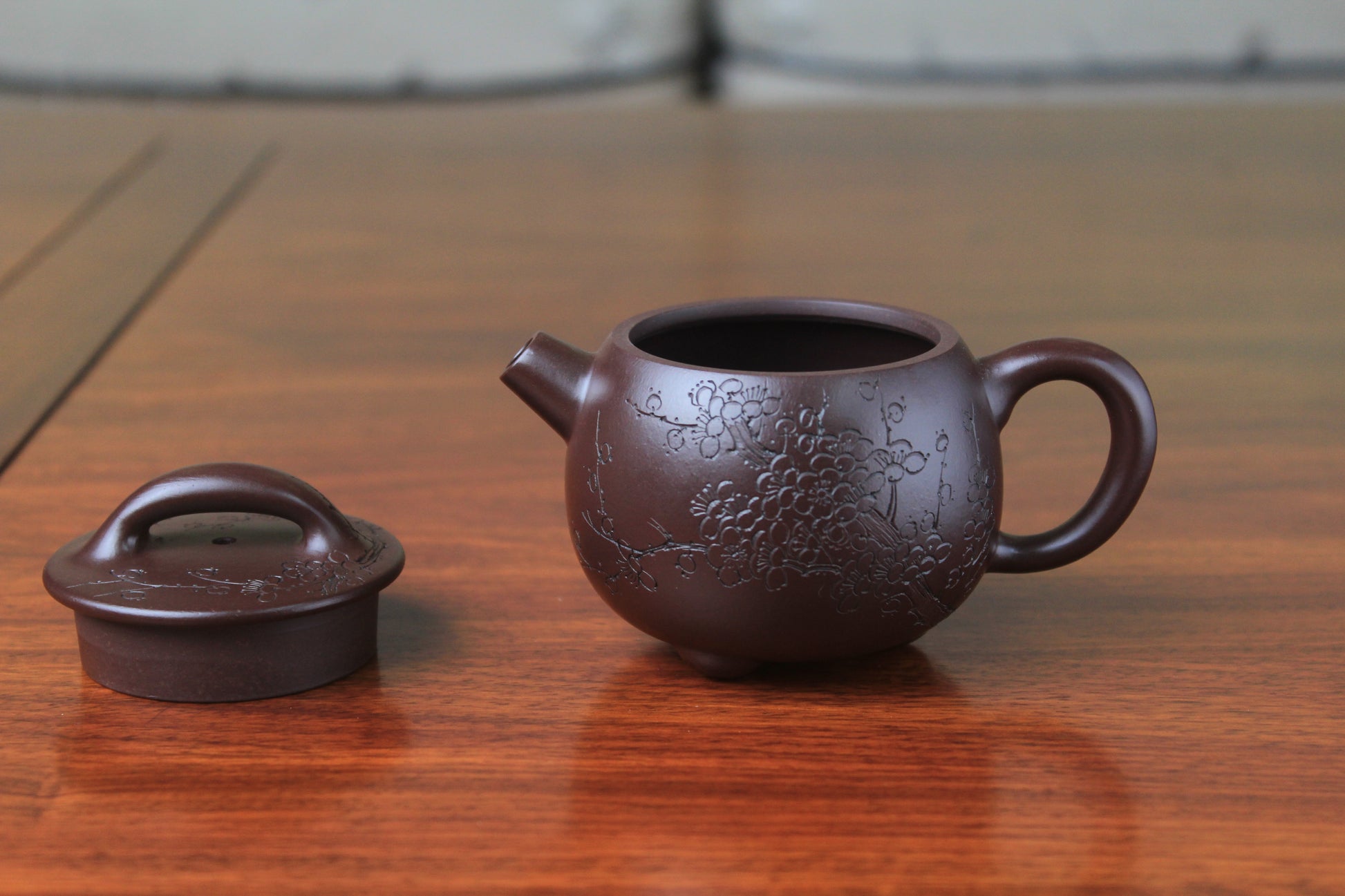 detail of this cute chinese teapot handmade with purple clay on the table