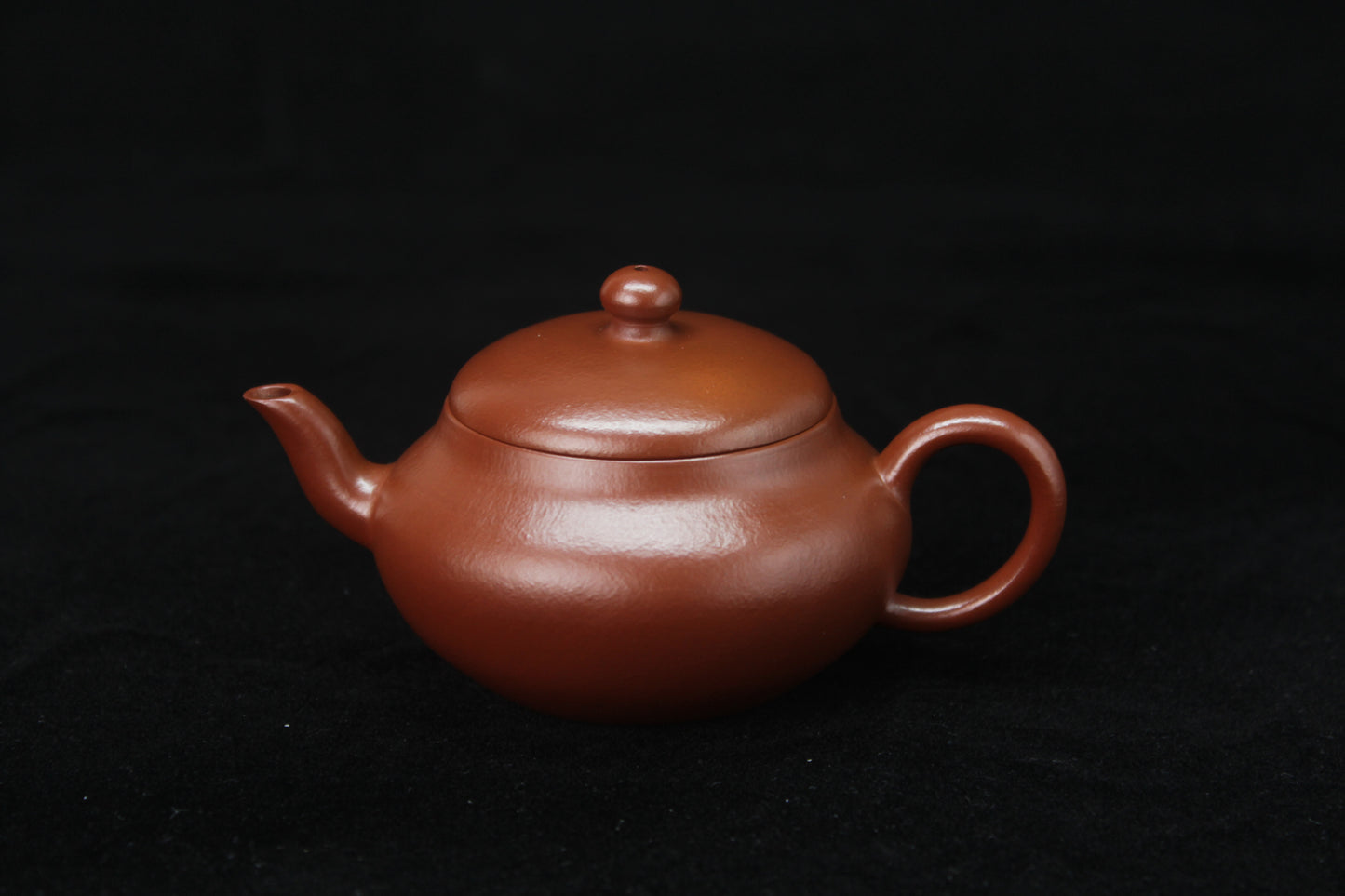 Front of Clay teapot handmade with purple clay from zisha art galley