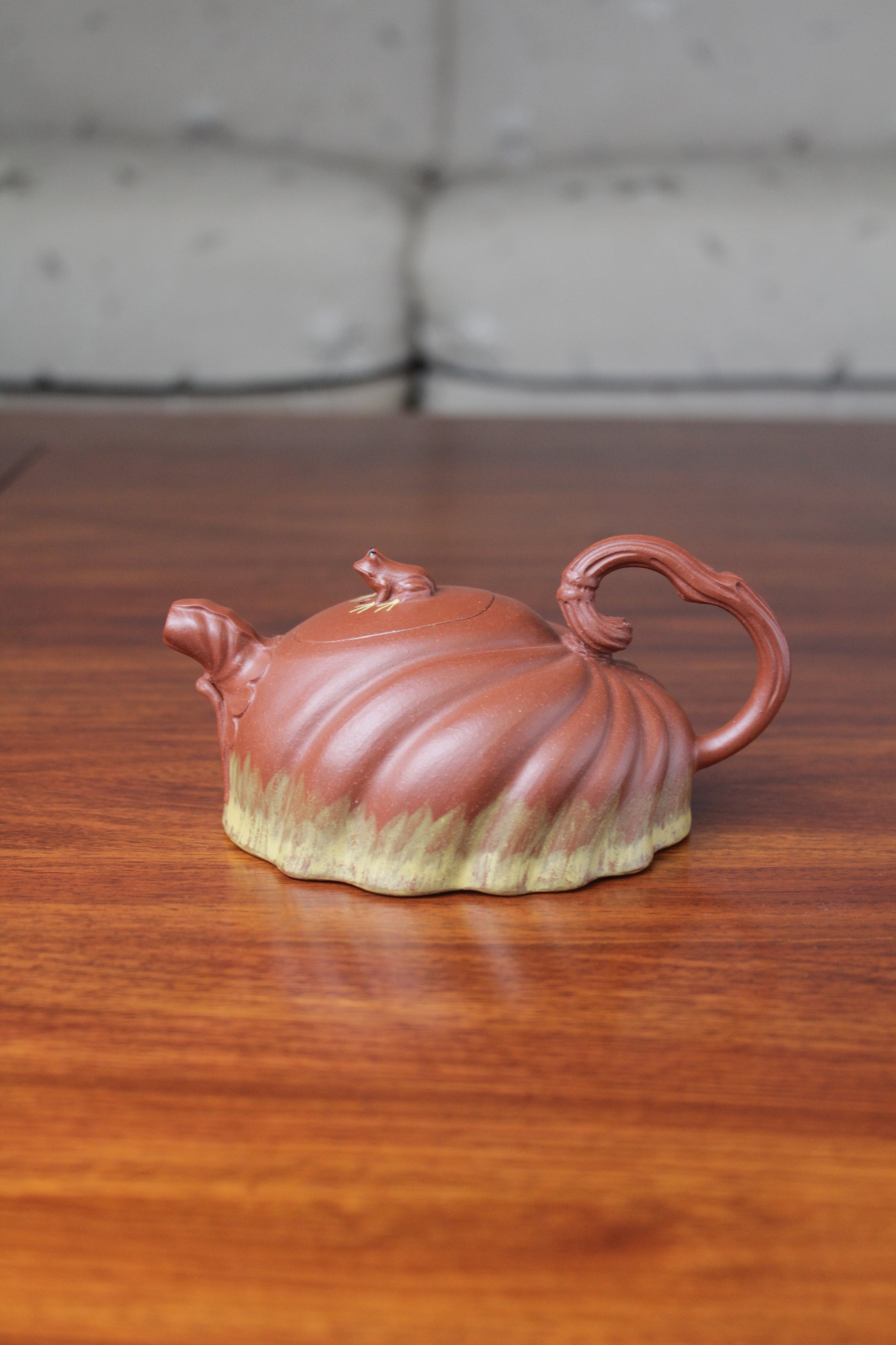 Front view of Collectible teapot handmade by teapot artist on the table