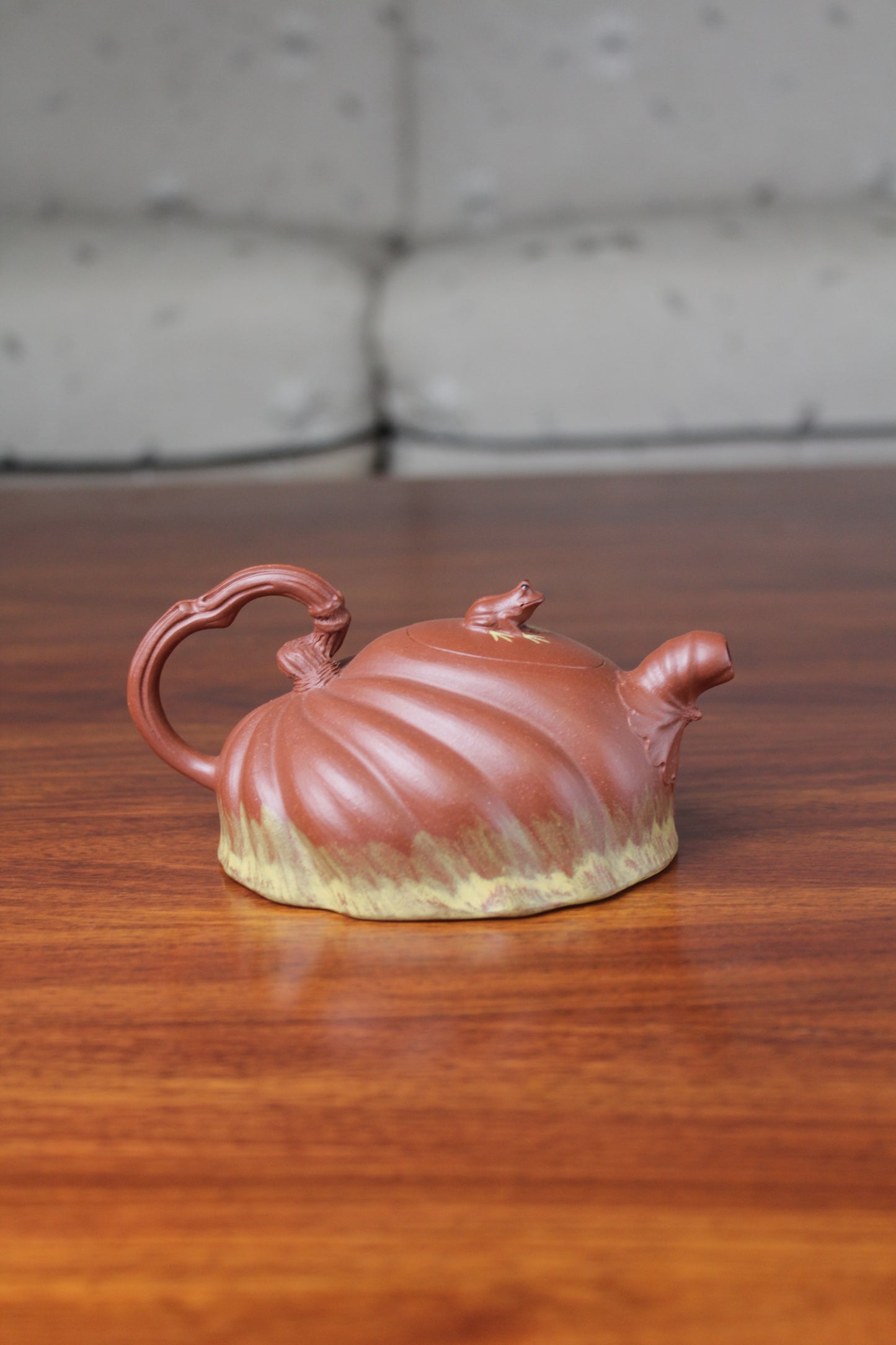 Back view of the Collectible teapot handmade by teapot artist on the table