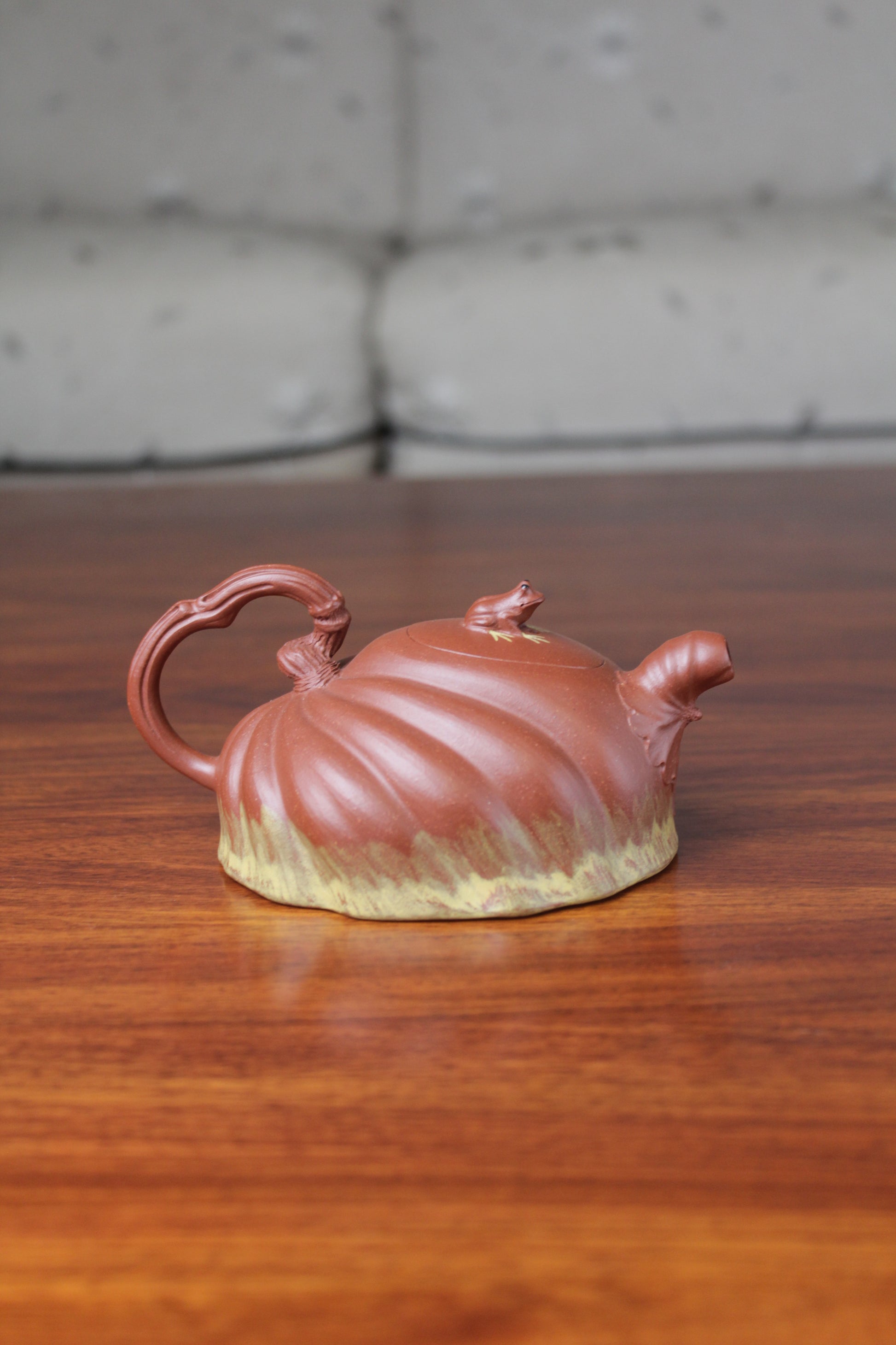 Back view of the Collectible teapot handmade by teapot artist on the table