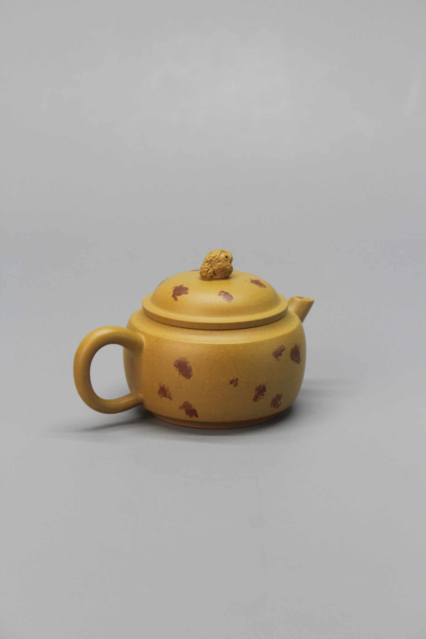 A cute small teapot for one back left