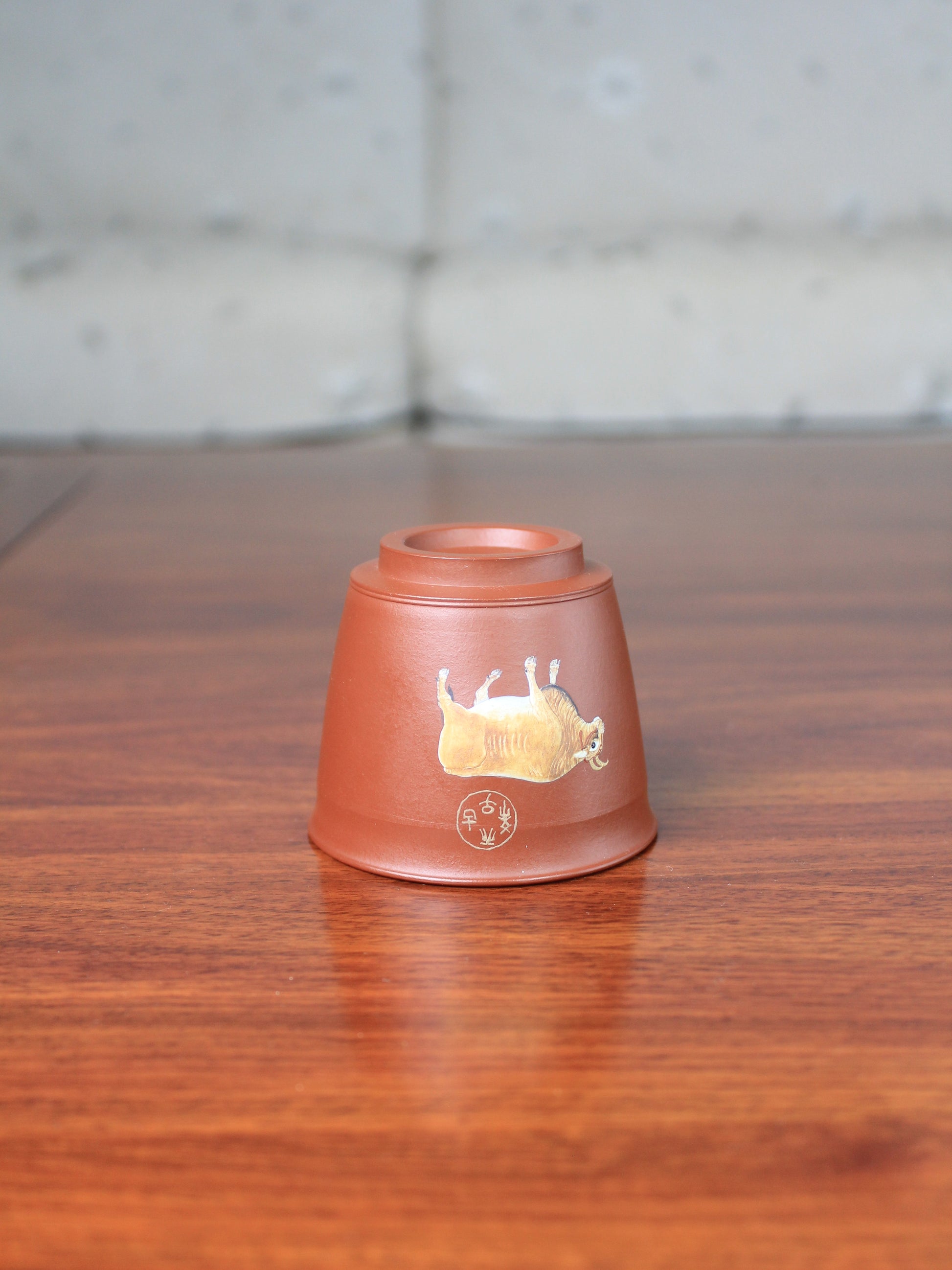 Detail of the vintage teacup with bull pattern