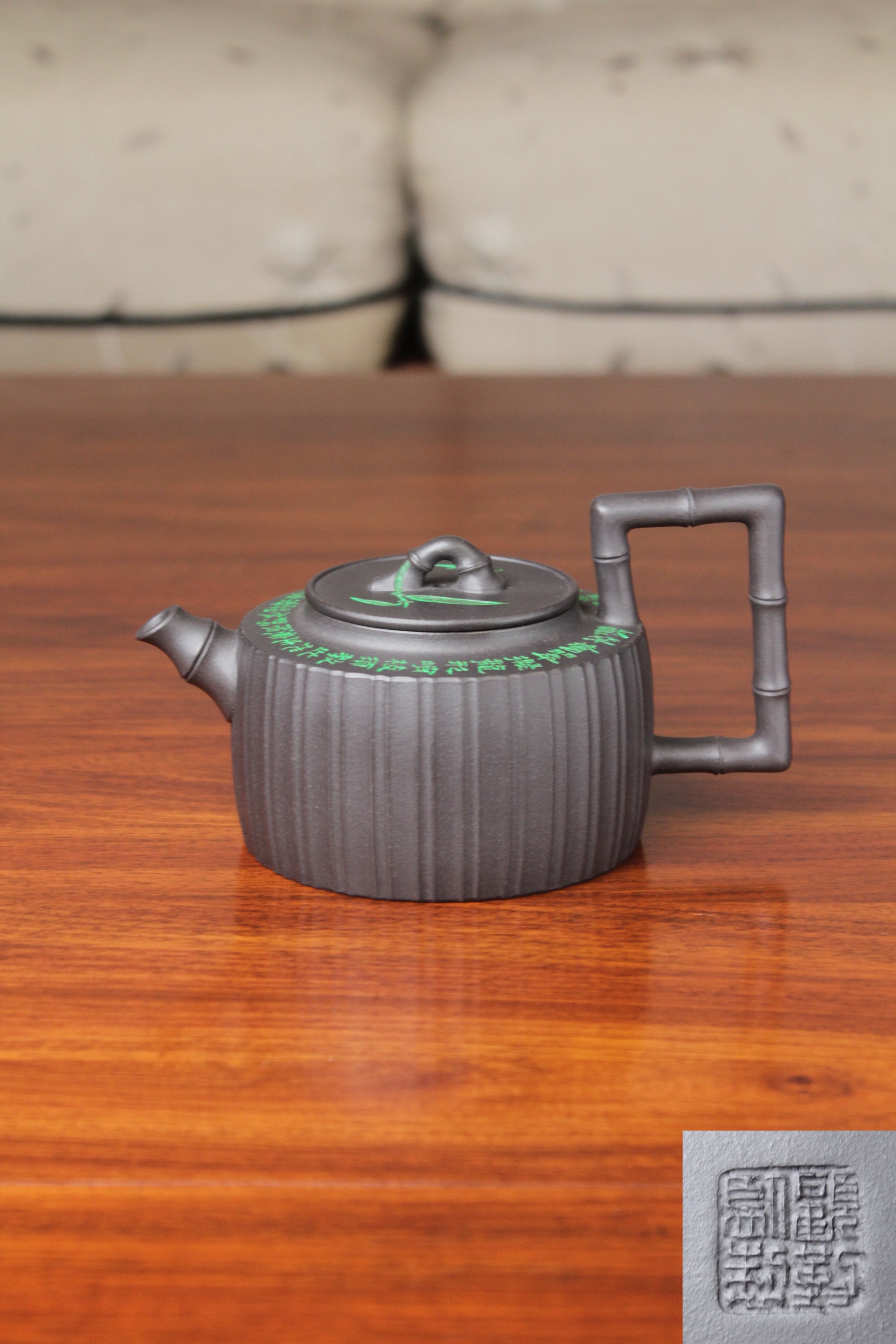 the vintage teapot handmade with purple clay and mark on the table