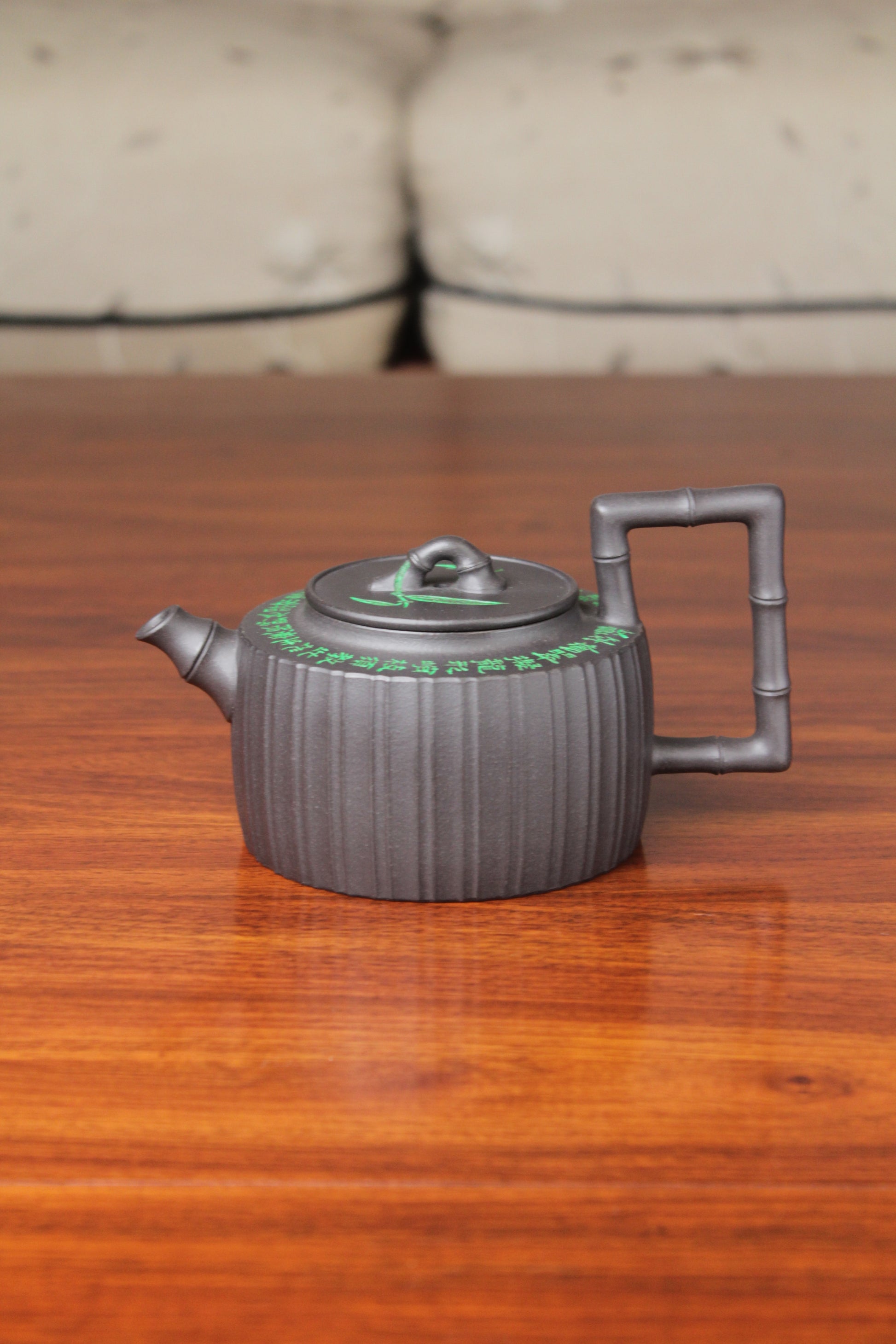 the vintage teapot handmade with purple clay on the table