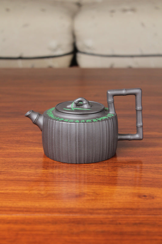 the vintage teapot handmade with purple clay on the table