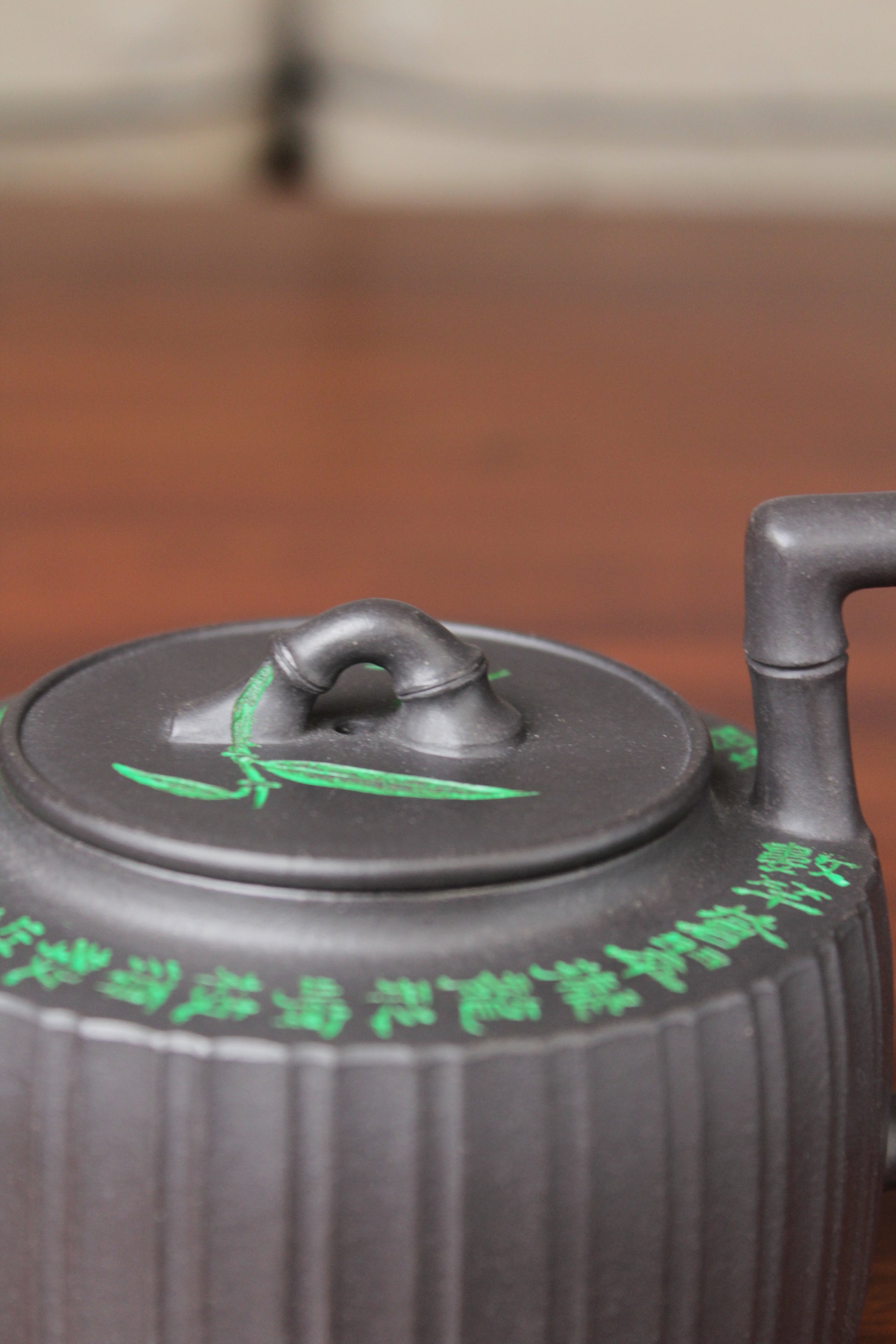 lid of the vintage teapot handmade with purple clay on the table