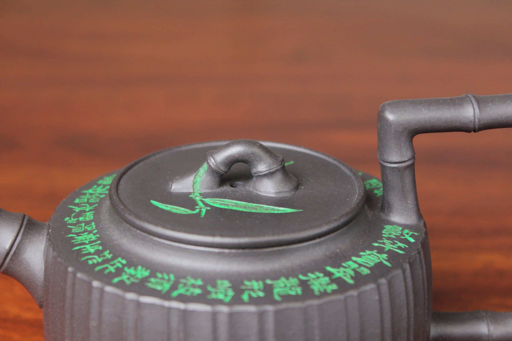 lid details of the vintage teapot handmade with purple clay on the table