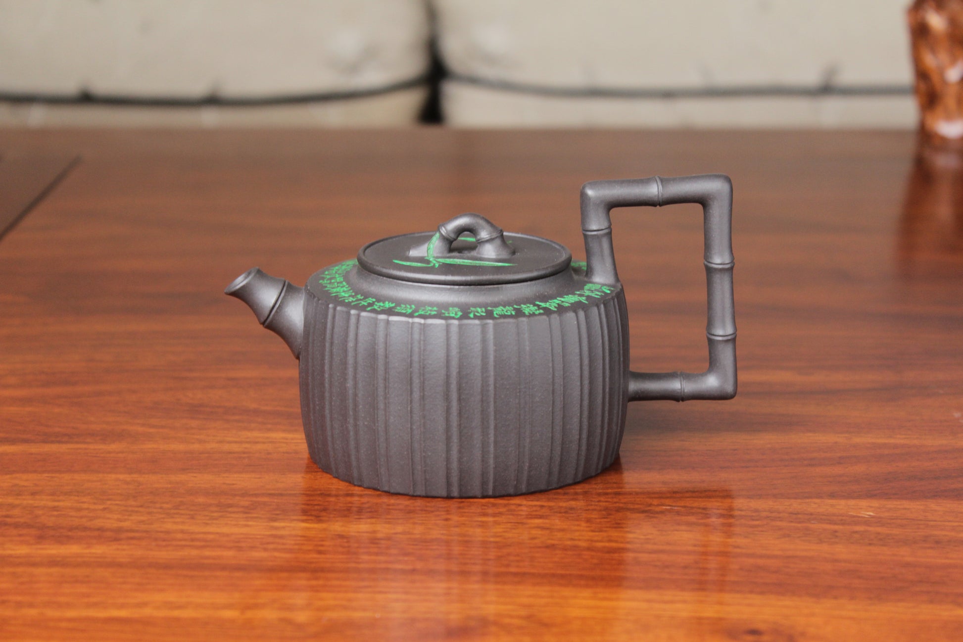 front of the vintage teapot handmade with purple clay on the table