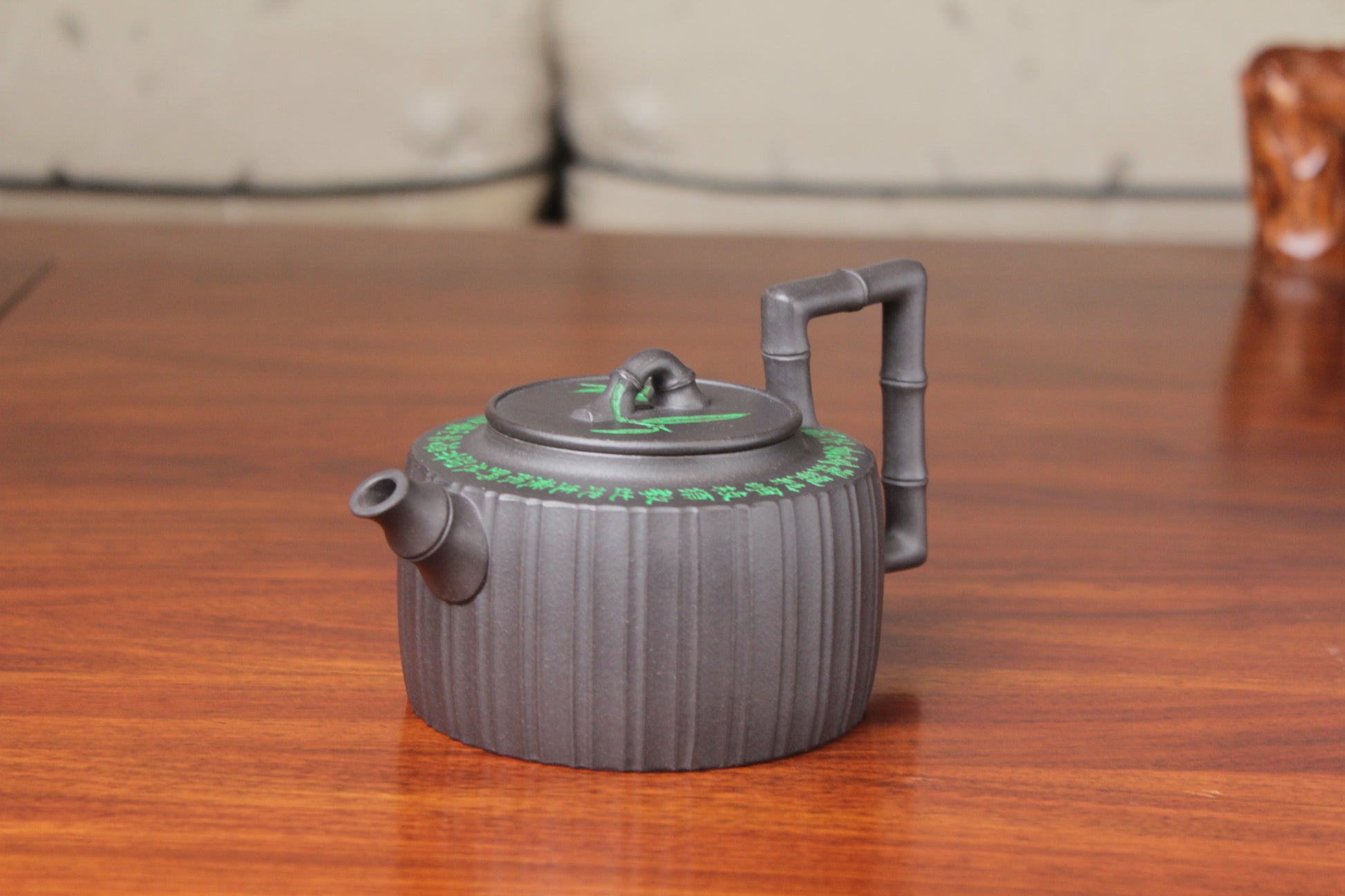 The vintage teapot handmade with purple clay on the table