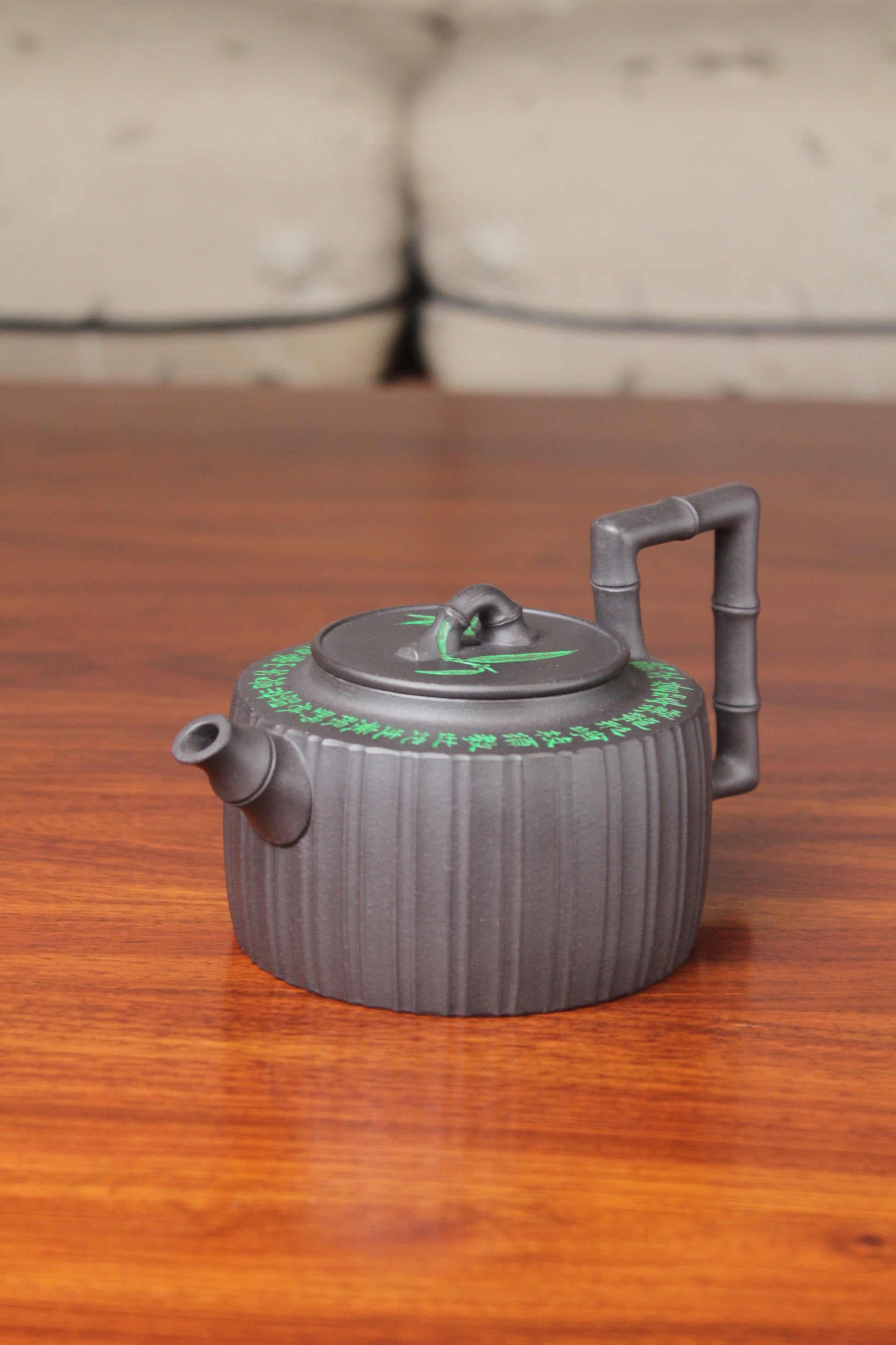 right of the vintage teapot handmade with purple clay on the table