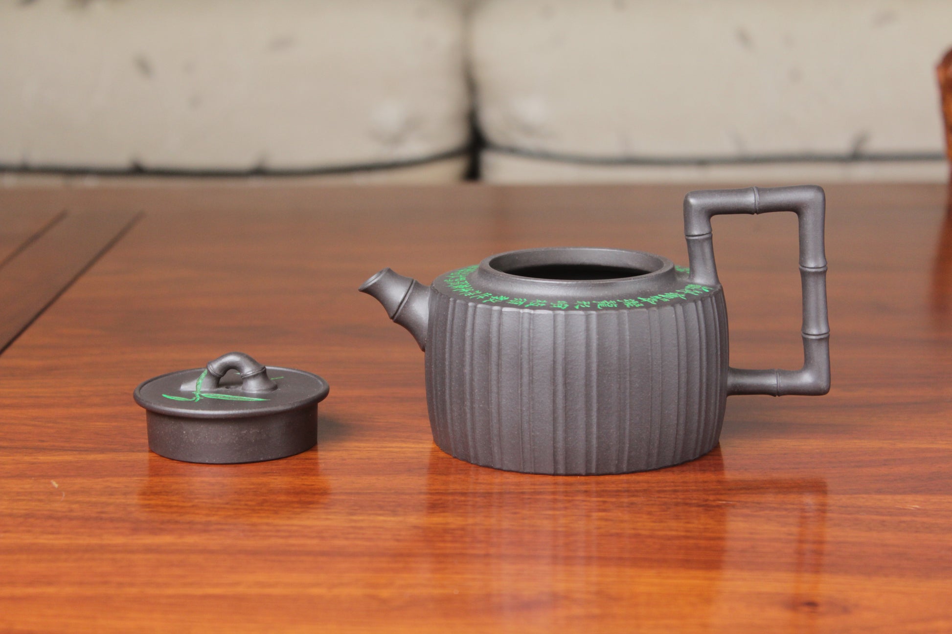 the lid of the vintage teapot handmade with purple clay on the table