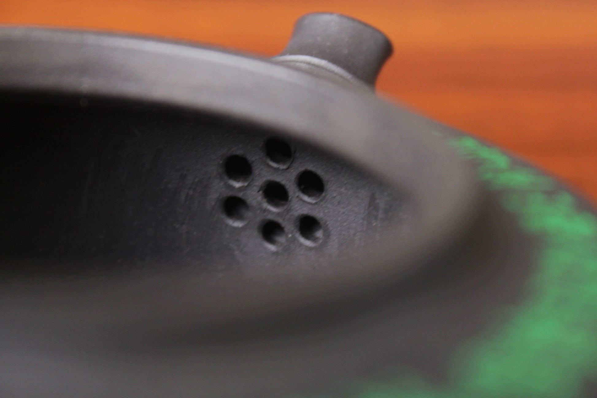 Filter of the vintage teapot, handmade with purple clay on the table