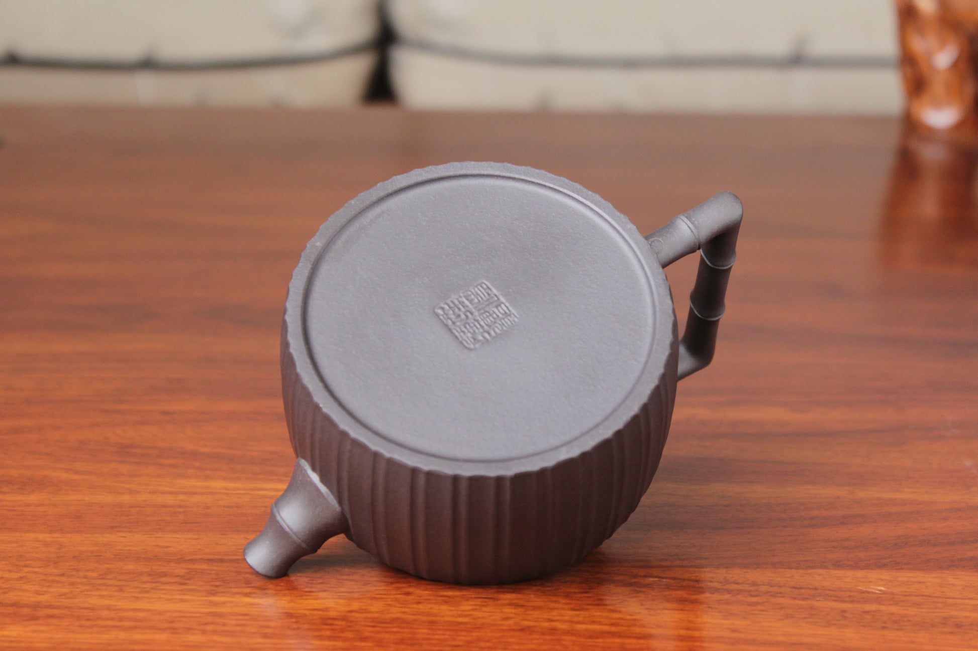 bottom mark of the vintage teapot handmade with purple clay on the table