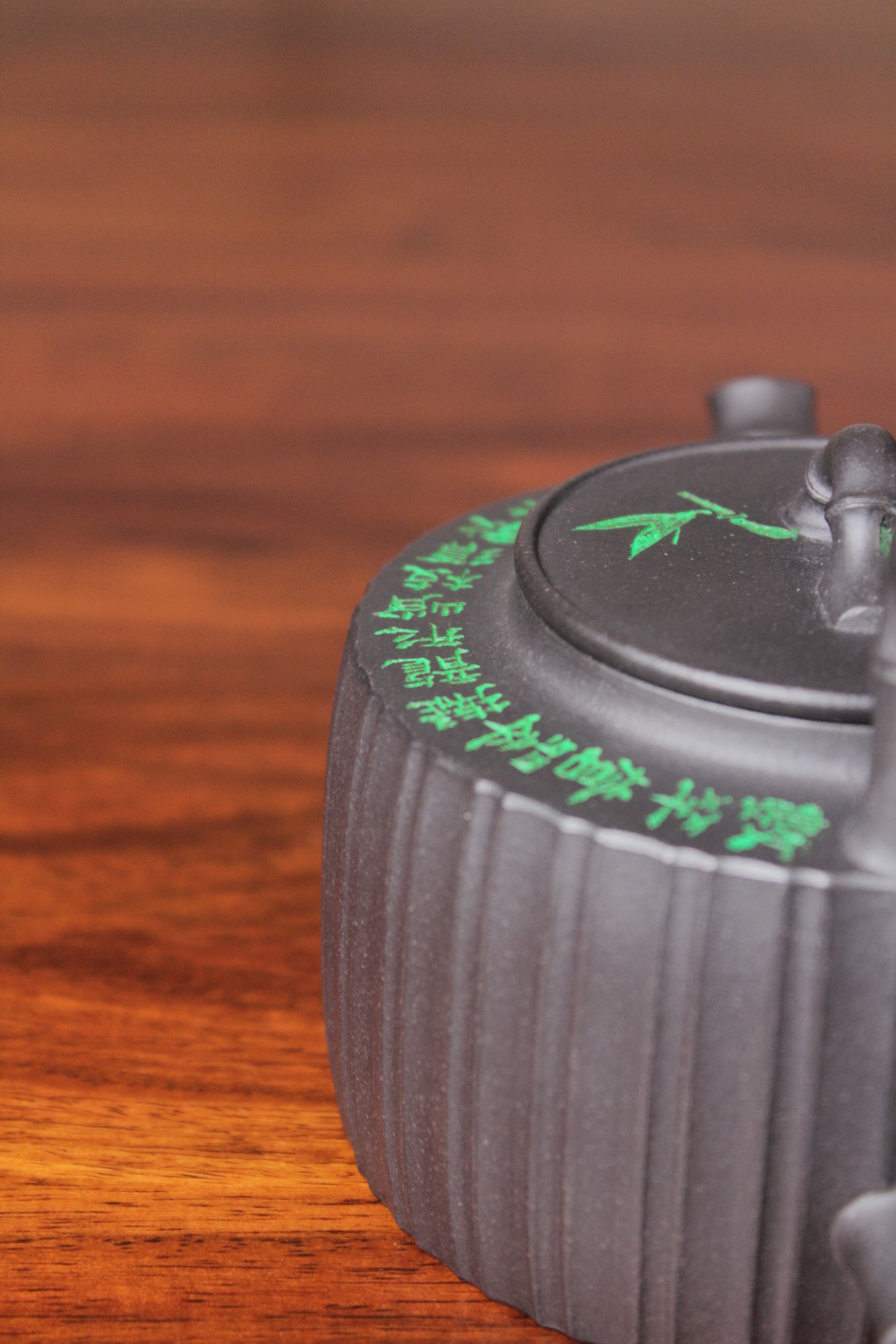 detail of the vintage teapot handmade with purple clay on the table