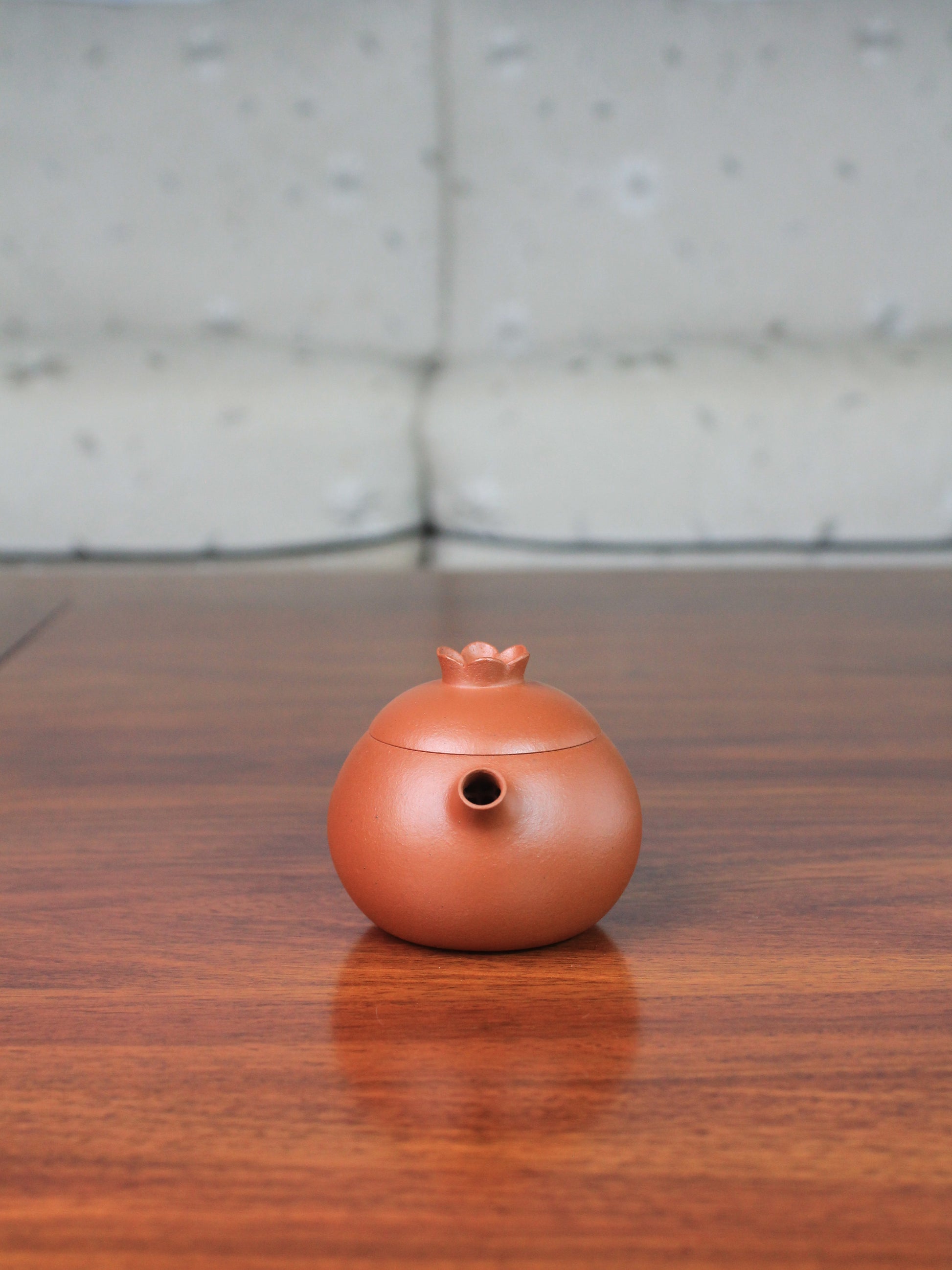 front view of yi shing teapot named flower on the table