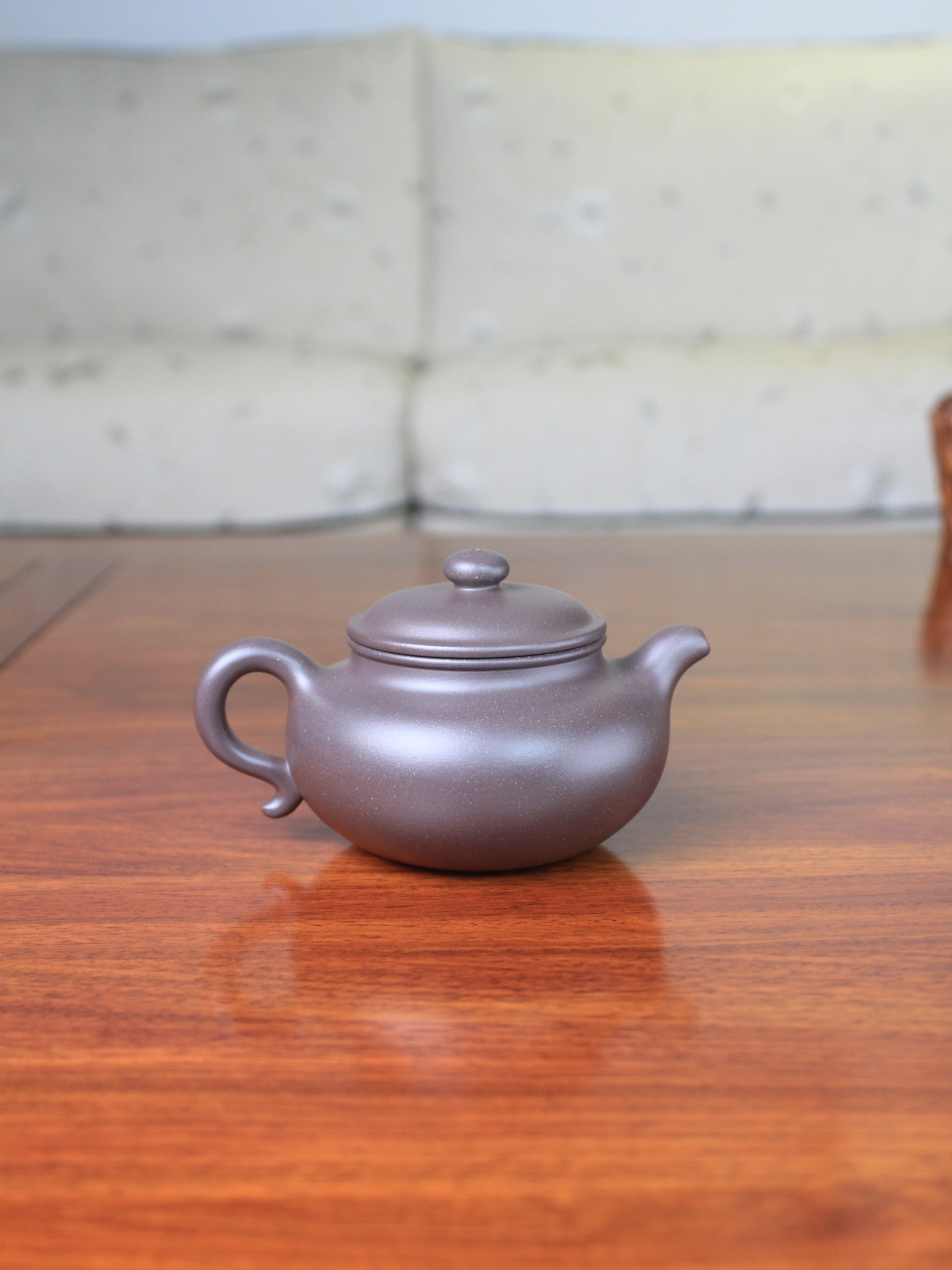 Back view of the yi sing teapot on the table
