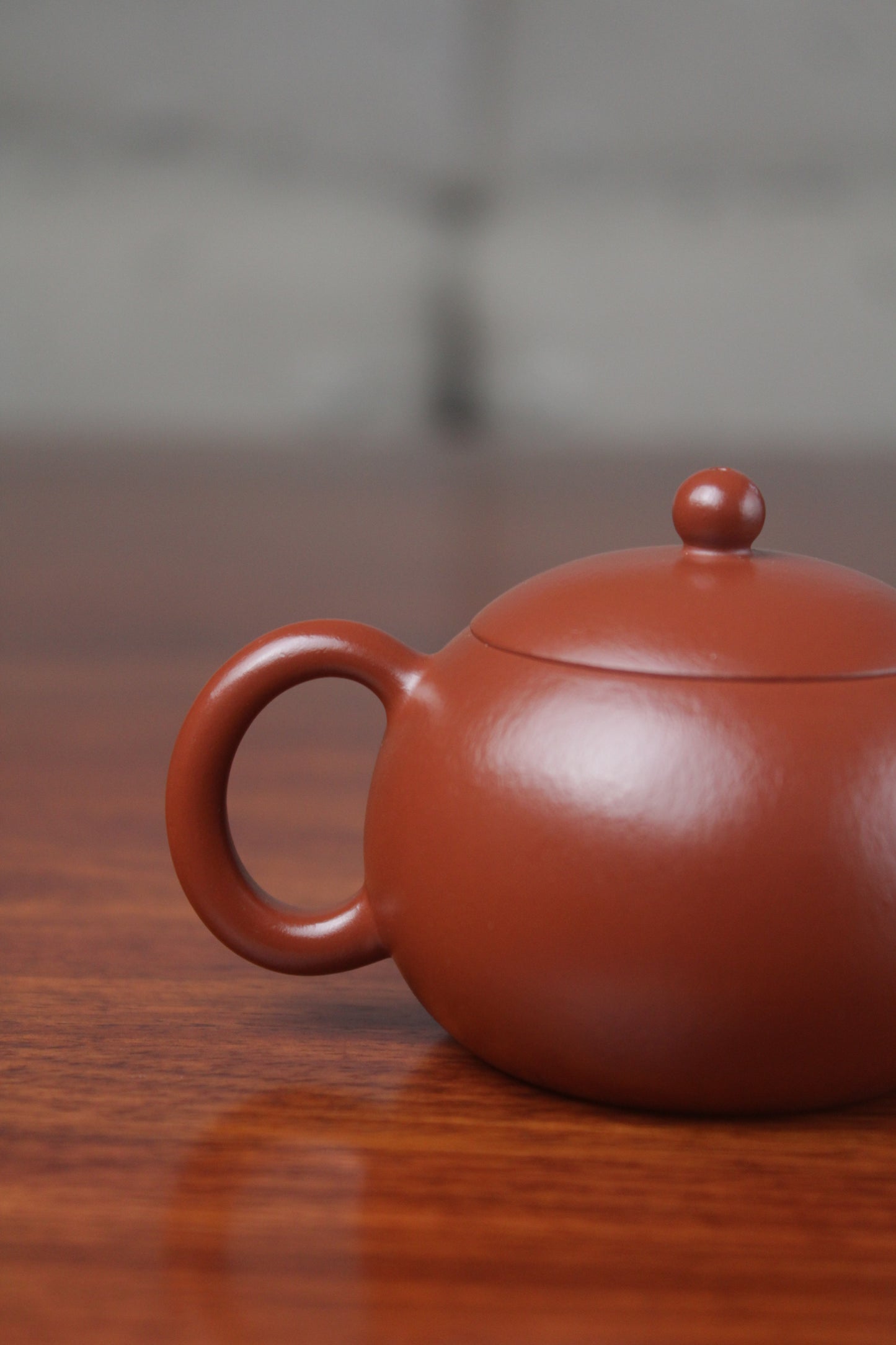 handle of the yixing clay teapot xishi on the table