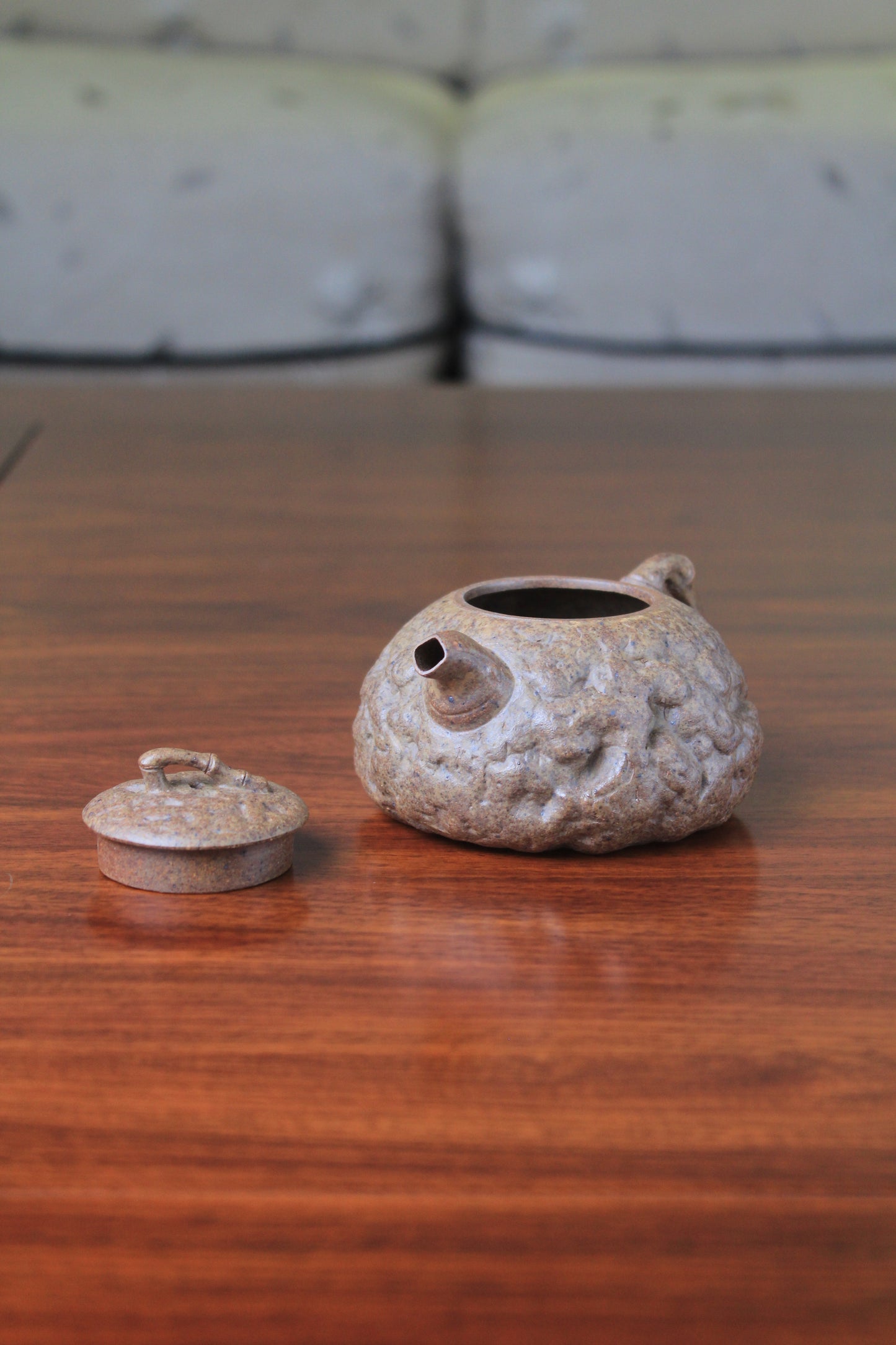 right of yixing teapot gong chun fully handmade with purple clay on the table