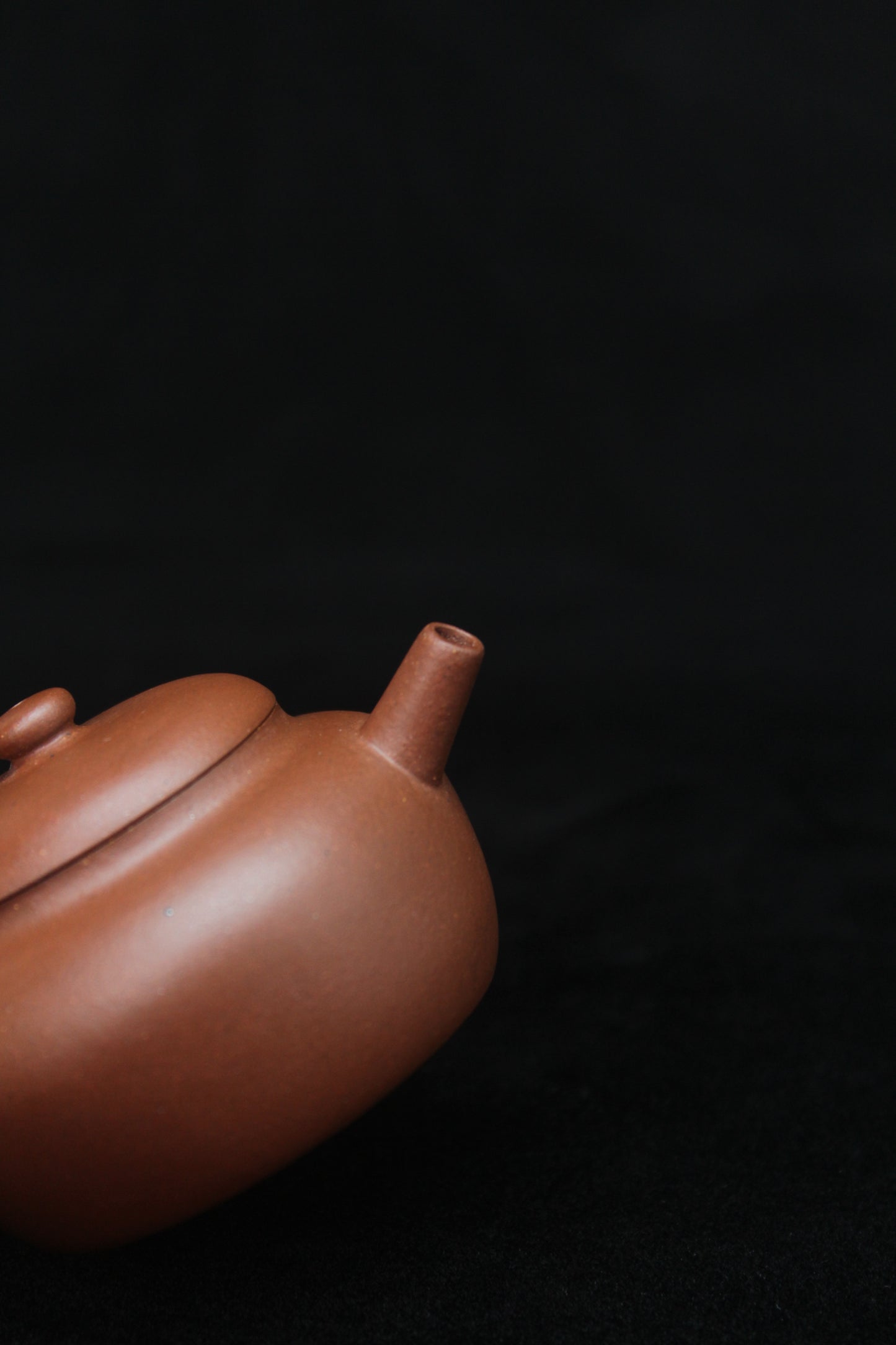 Spout of a vintage small Yixing teapot made of dicaoqing purple clay