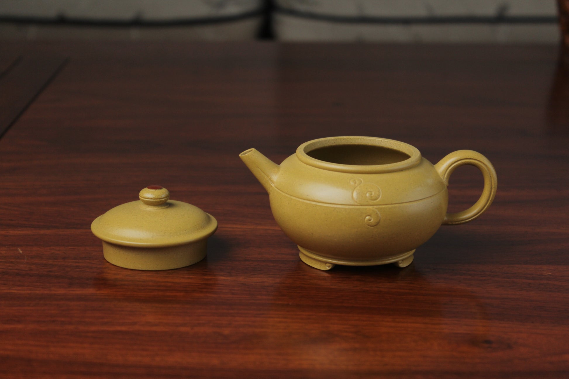 the zisha teapot and lid on the table, handmade with purple clay from teapot art zisha art gallery