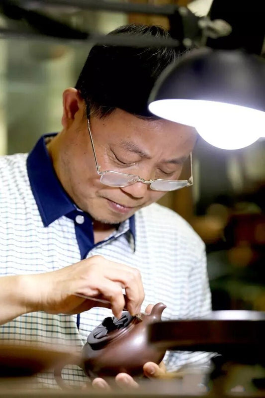 Yixing teapot artist Zhang Yaojian is making a teapot