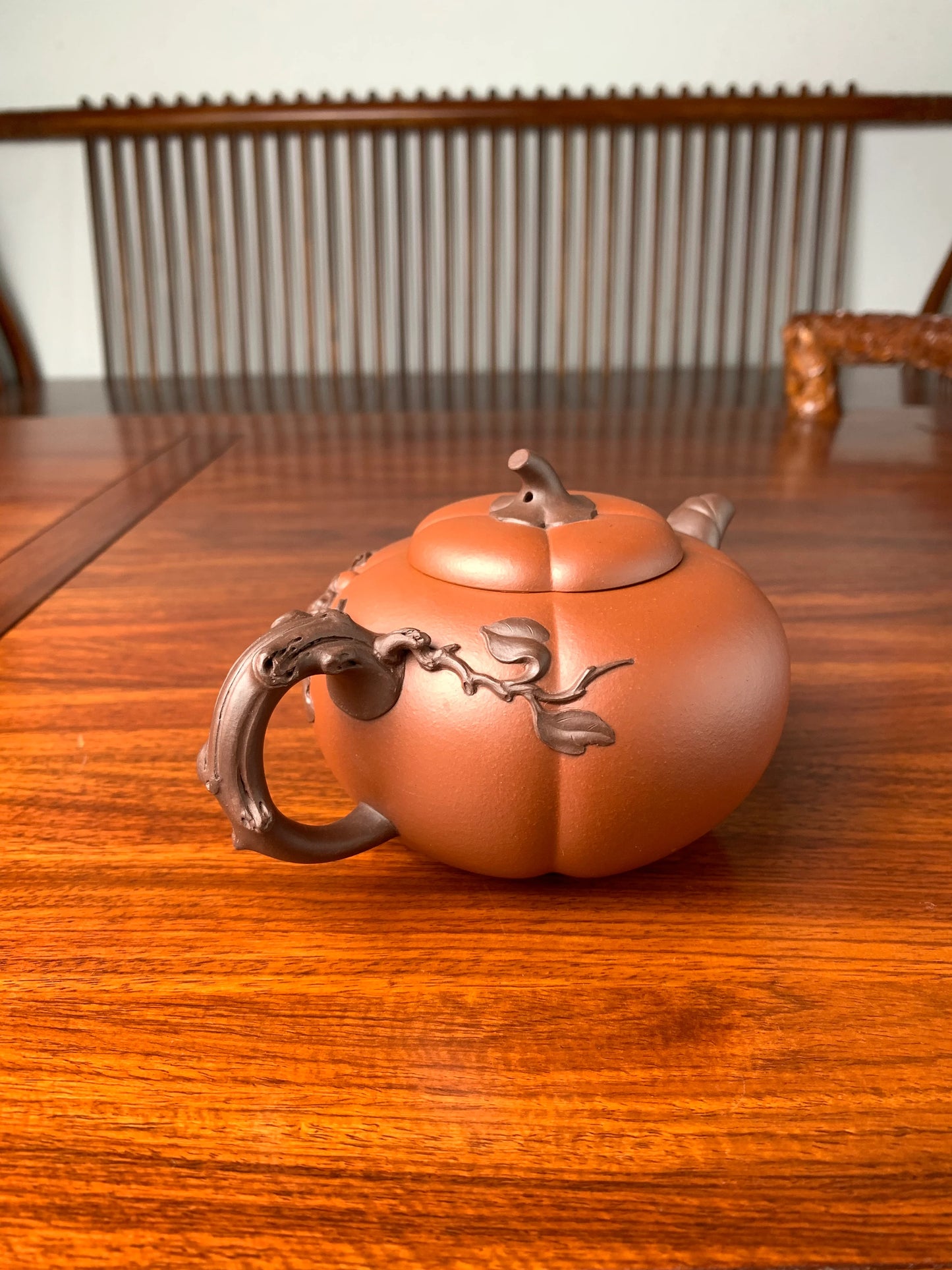 left view of art collection teapot named pumpkin on the table