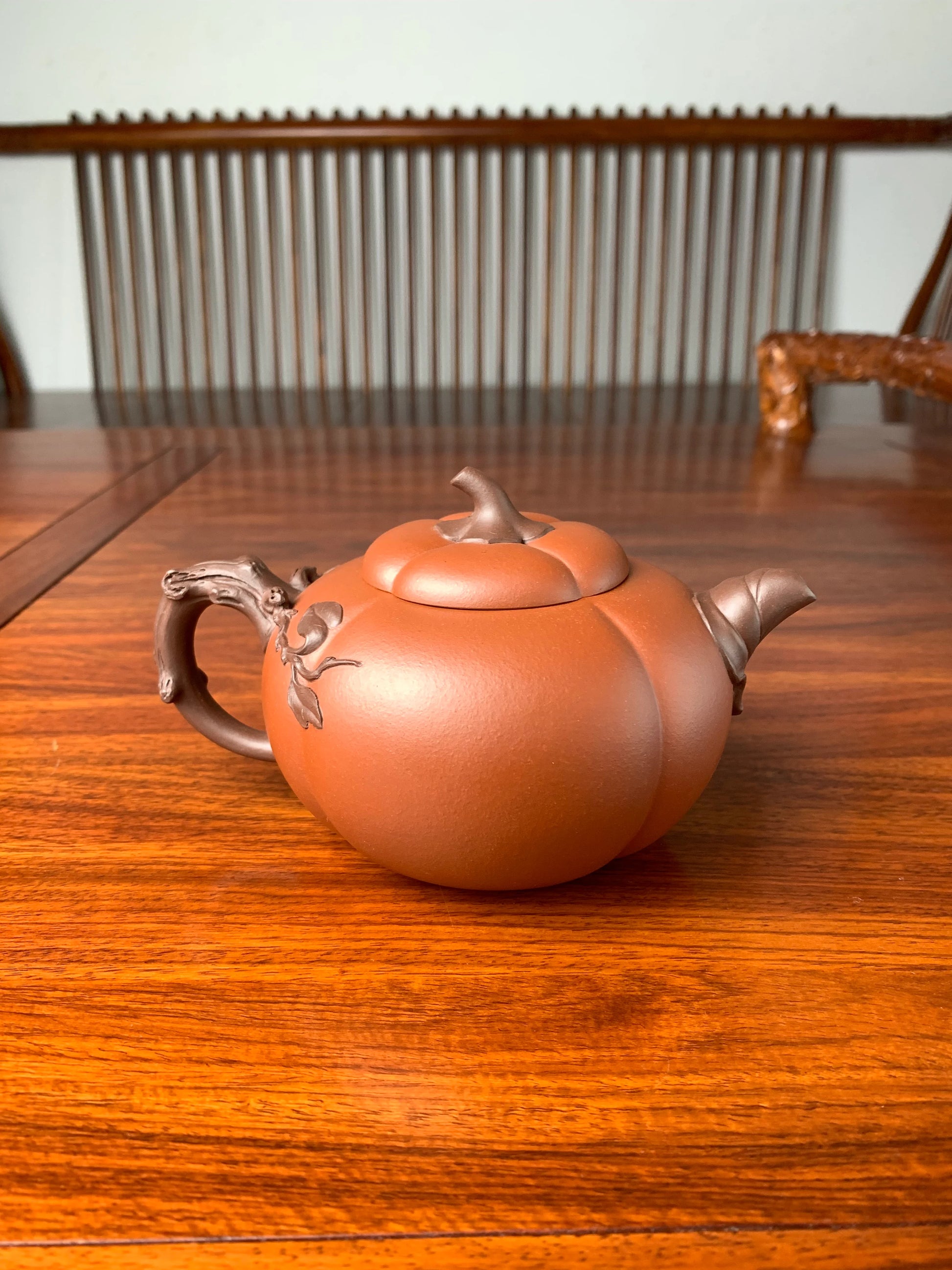 back view of art collection teapot named pumpkin on the table