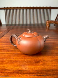 back view of art collection teapot named pumpkin on the table