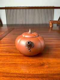 front view of art collection teapot named pumpkin on the table