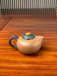 the artistic teapot on the table back view