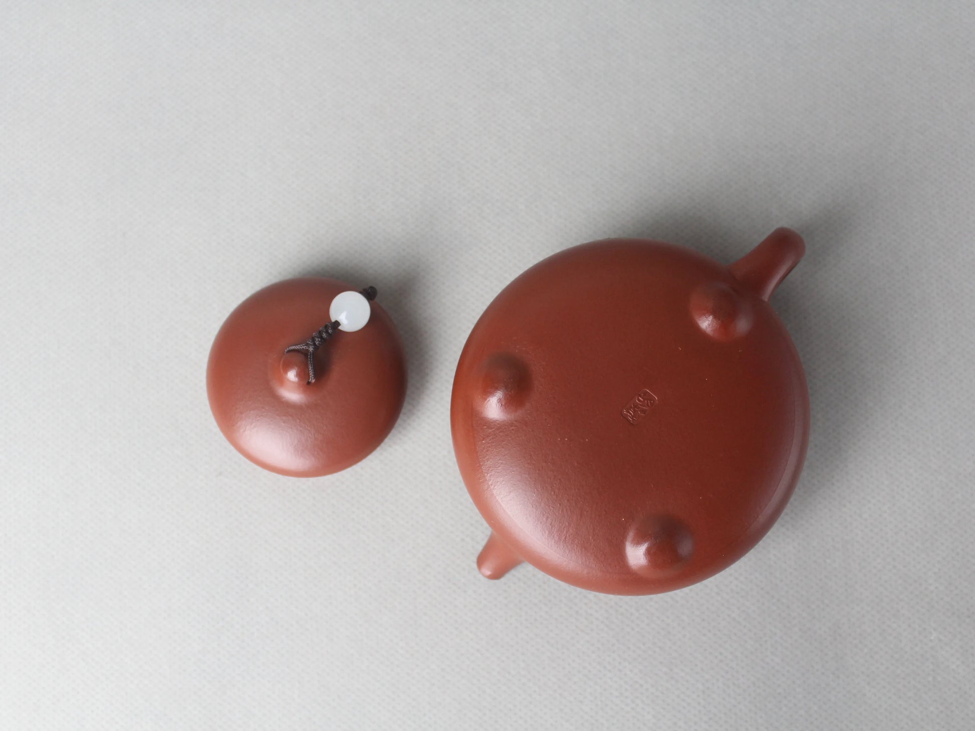 The bottom of the artwork teapot named "Egret," 