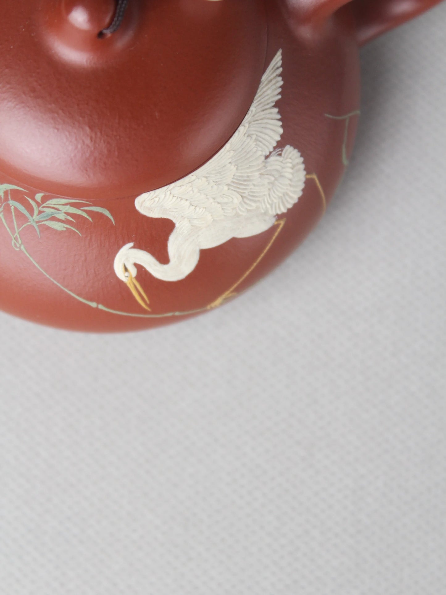 the detail of the painting on the artwork teapot