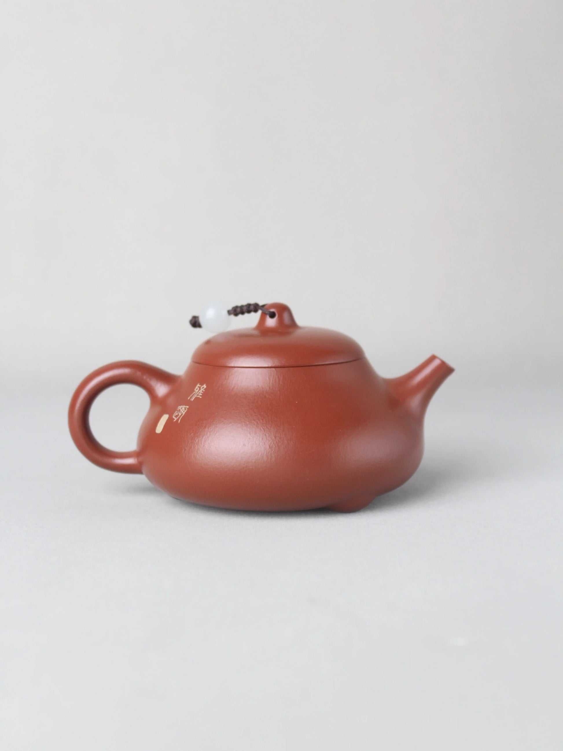 The back view of the artwork teapot named "Egret," handmade by the artist