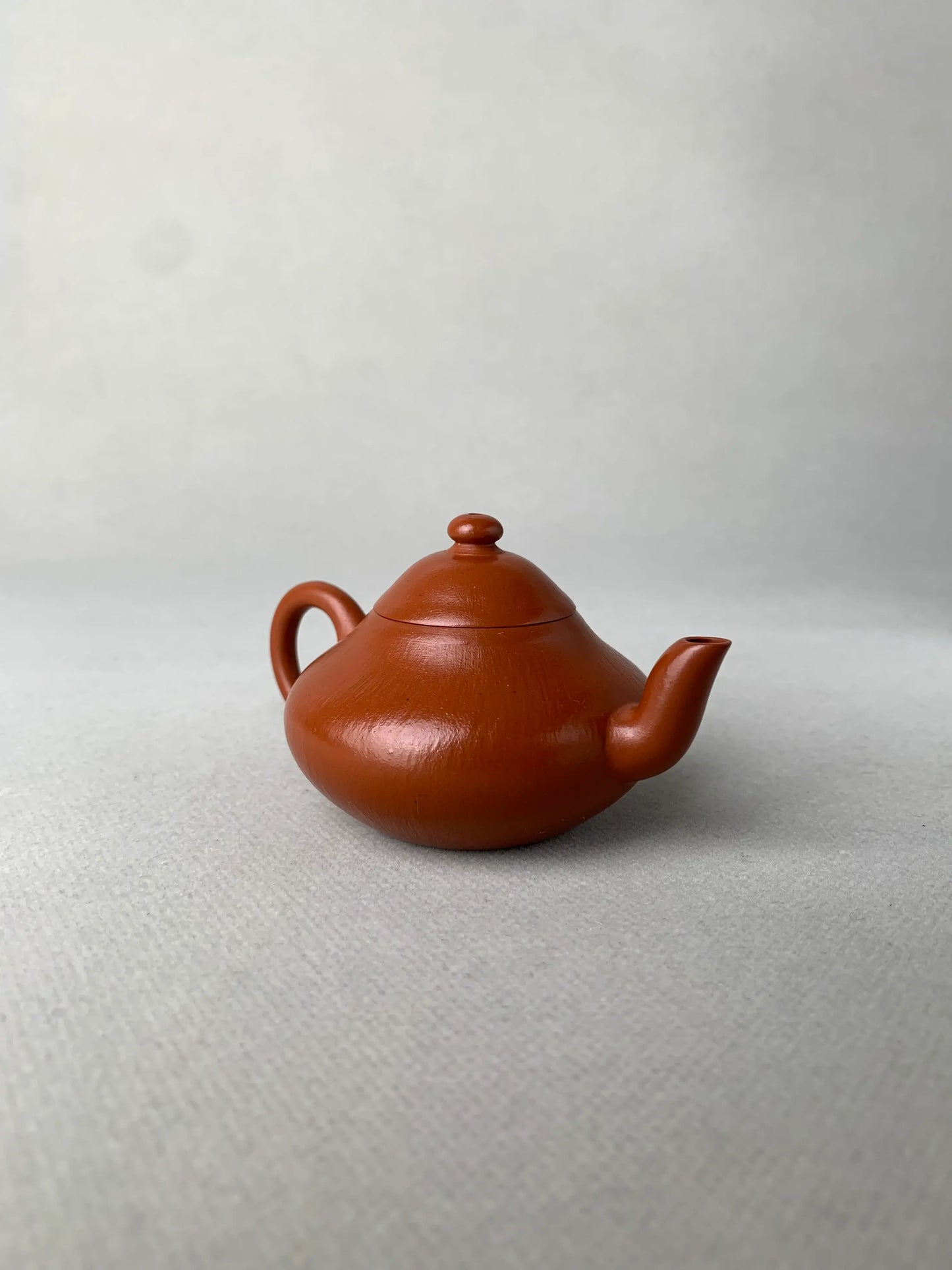 left view of authentic yixing teapot named li xing on the table