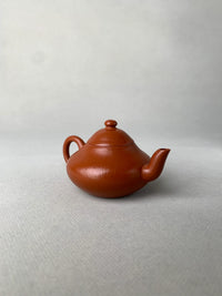 left view of authentic yixing teapot named li xing on the table