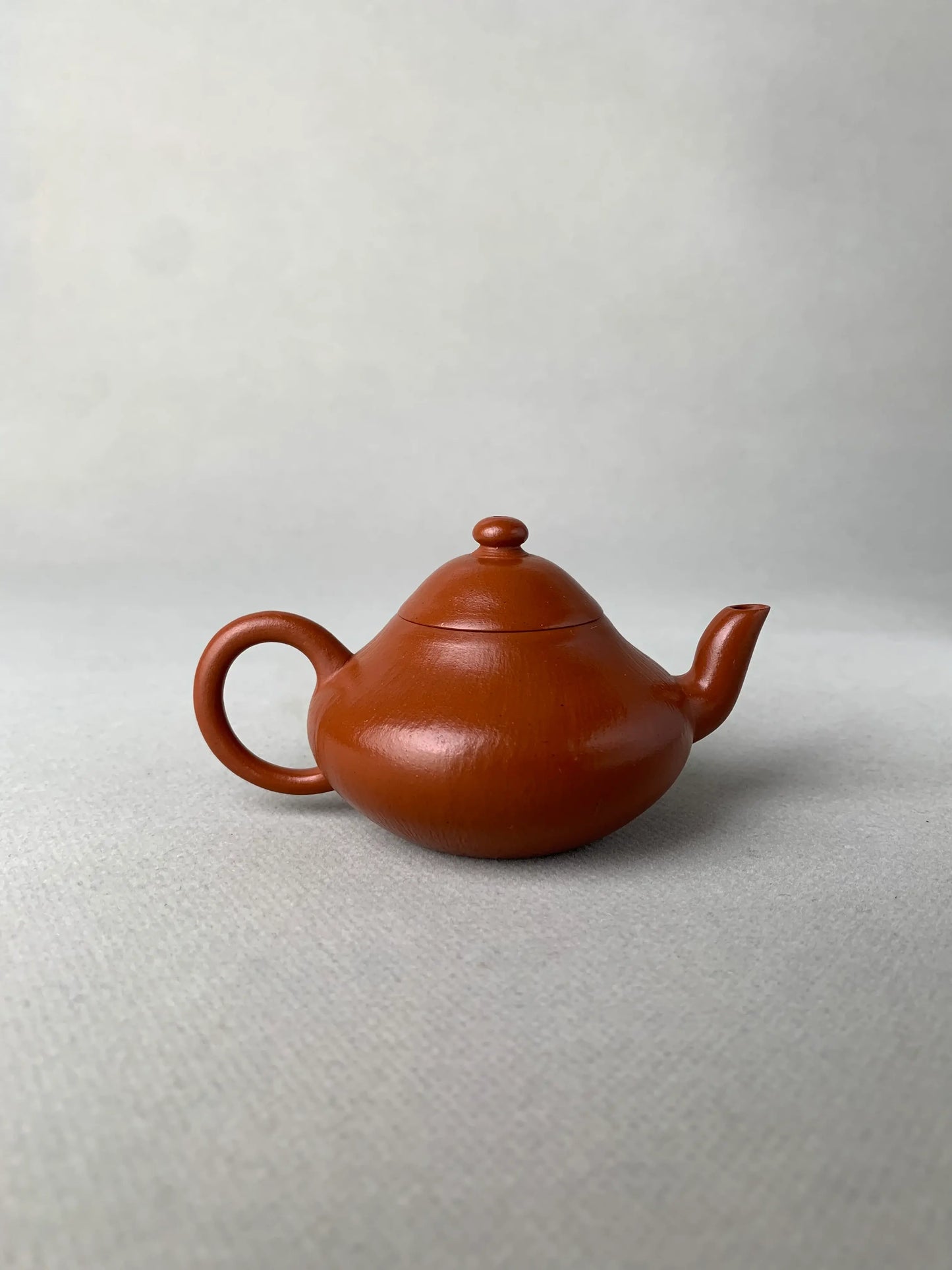 back view of authentic yixing teapot named li xing on the table