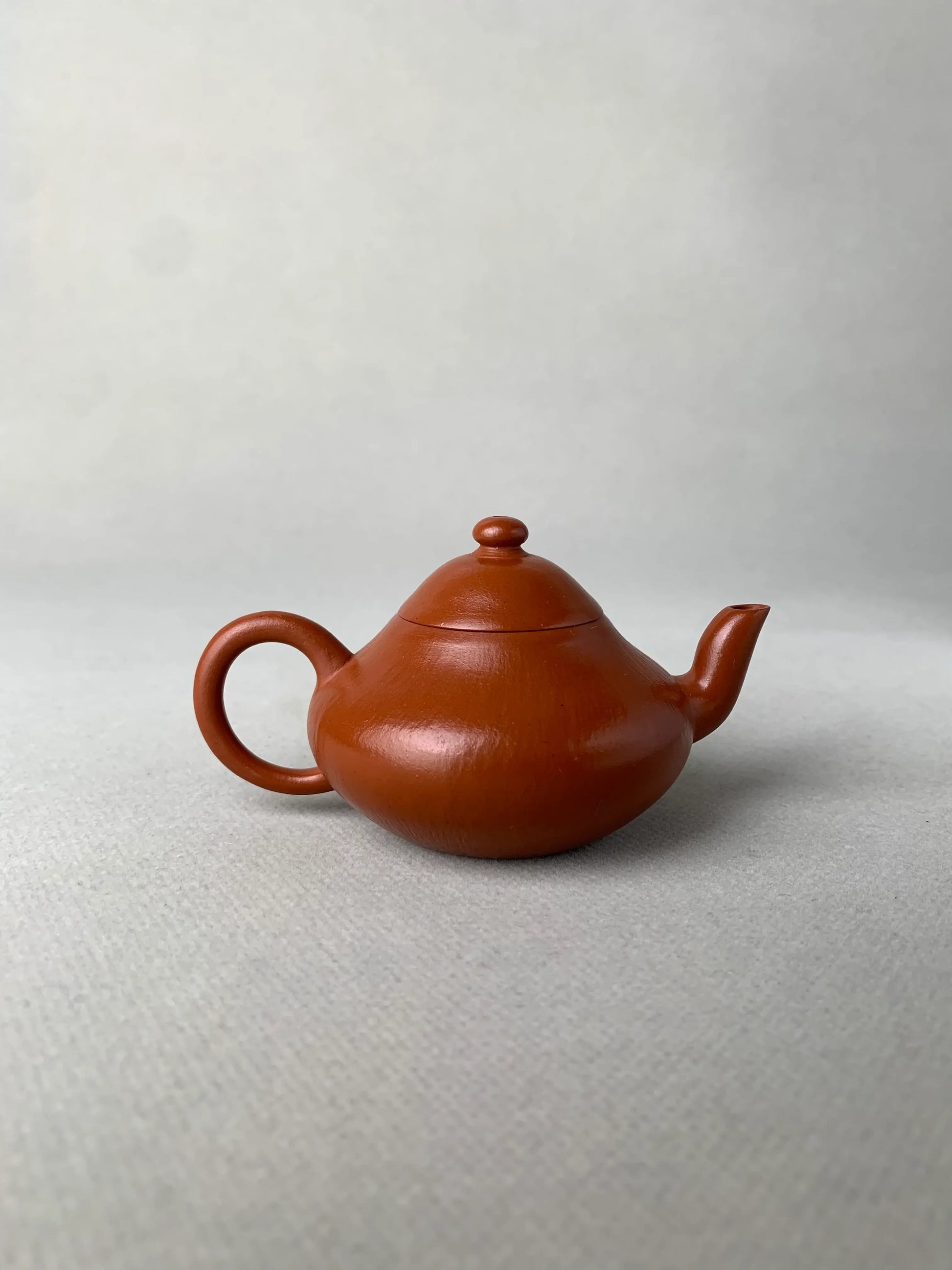 back view of authentic yixing teapot named li xing on the table
