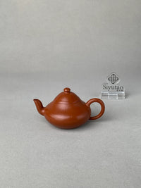 Front view of the authentic Yixing teapot on the table