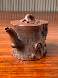 Left-side view of the pine-bark decoration on the handle of this beautiful teapot called Pine Tree