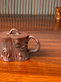 the handle of the beautiful teapot named pine tree