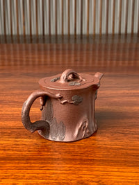 Look at the handle of this beautiful teapot from the right side